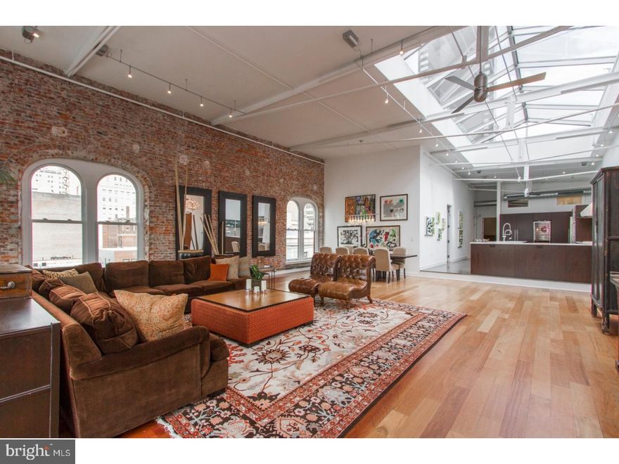 Own a piece of history in this extraordinary developer's penthouse at The White Building!  This one-of-a-kind unit is embedded within one of Philadelphia's trendiest and most vibrant neighborhoods, Midtown Village. This exceptional 3 bed 3 bath home possesses high-end finishes as well as a custom 30'x15' skylight spanning the entire kitchen. Features of the 3,149 sq. ft. apartment include 15 ft ceilings, Brazilian cherry hardwood flooring, original exposed brick walls, expansive living and dining areas and oversized windows. The living area contains an open-concept living room, dining room, and kitchen. The kitchen is equipped with top of the line appliances such as Gaggenau, Sub Zero and Wolf, a large island counter with seating for four, an indoor Grill with the Wolf Hood, Lagos Azul tile, Calcutta Gold custom counters and a large wine fridge and pantry. Two of the home's spacious bedrooms lie opposite the kitchen, each connected by a jack and jill bathroom with dual vanity and shower/tub. Further, you will find the Master Suite complete with large walk-in closet, and stunning master bath with large shower, soaking tub and dual vanity with marble top. Additionally, there is a quaint office and full laundry room off the kitchen, an attic above the master closet, dual zoned HVAC, 2 car parking, and additional storage spaces in the basement of the building. In this amazing location, you will be close to all major attractions including high end shopping, award winning restaurants, Rittenhouse and Washington Square parks and much more. You will also have easy access to local and regional trains, major highways and Philadelphia International Airport. Don't wait, schedule your showing today!