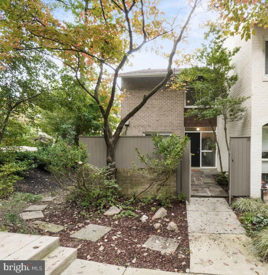 End unit townhouse on the water in the beautiful and peaceful setting of New Mark Commons, close to public transportation and restaurants/shops.   This well-cared-for lakefront property has a charming courtyard entrance with lots of privacy, a new roof, a skylight and large windows letting in lots of light, a Trex deck with lake views (retractable awning), and a unique shed with electrical for storing bikes, and garden tools.  Concord grapes in the side yard are available to harvest each season.  There are two very spacious primary bedrooms, each with their own dedicated full bath.  Hardwood floors gleam throughout the main and upper levels, a wood-burning fireplace warms the living room and the kitchen with newer appliances has access to the front courtyard.  The finished basement includes a surround sound speaker system, recessed lighting, separate laundry/utility room and a very spacious storage room.  Amenities include a large community swimming pool, clubhouse, tennis courts, basketball court, walking paths, a bike path, and playground.  Come see this hidden gem!