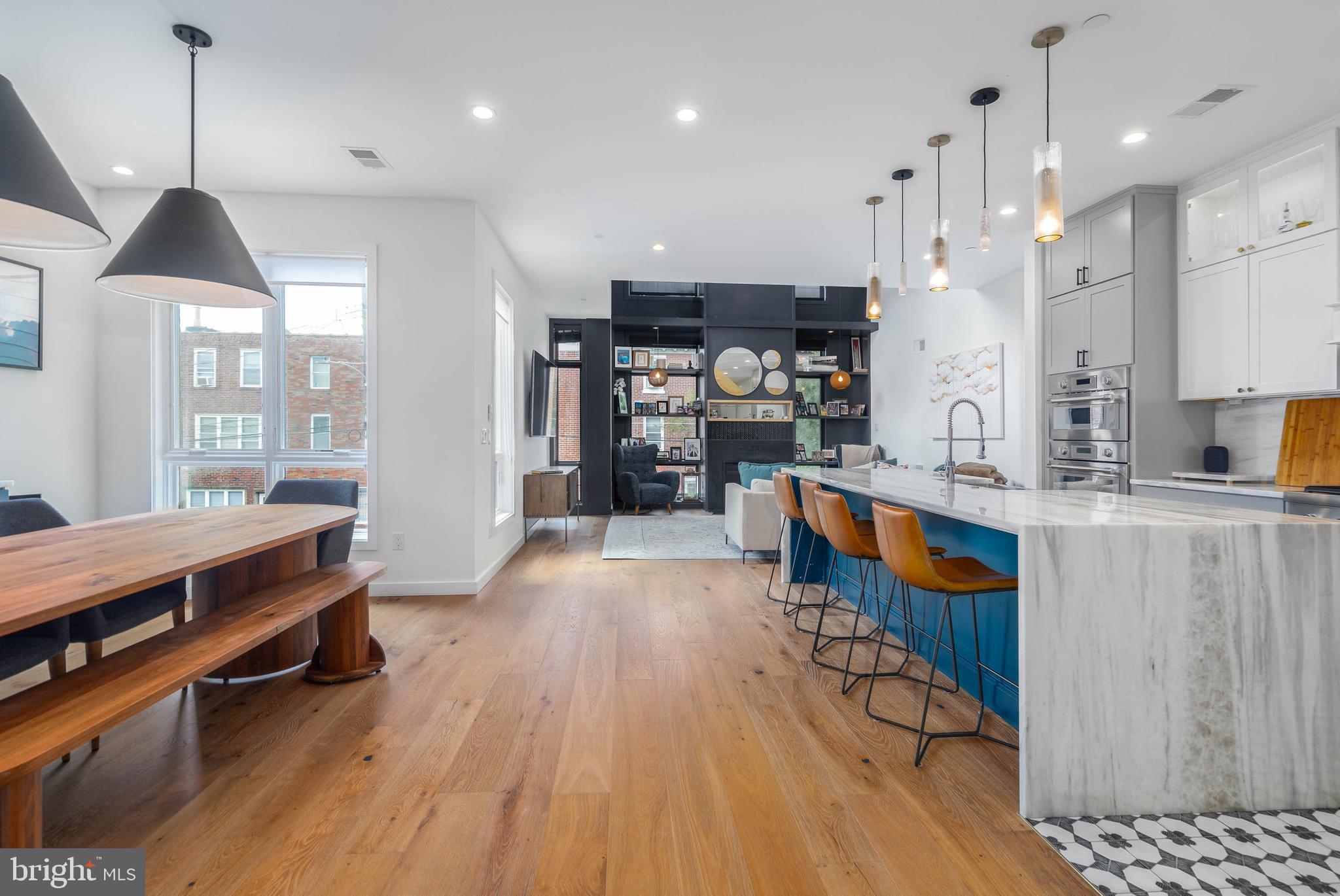 A Home Buyer is often left with tough decisions to make during their house hunt. Can we live without parking? Is the home too narrow? Can we live without a backyard? All of these questions and concerns can be left at the door of 2055 E Dauphin. Welcome to the Unicorn of Fishtown. Located on a massive 27' by 85' lot, this custom-built home was envisioned by GNOME architects and designed by rj lowercase. Square footage is no problem here - over 4,200 sqft of interior space spans the wide-open floor plan. Comfortably park in your GARAGE or driveway and enter this gorgeous foyer outfitted with chevron pattern brick floors and timeless trim work. The rear of your first floor includes a beautifully appointed office or bedroom with access to a full bathroom. The lower level is primed for entertainment - with MASSIVE 12' ceilings, this space is enormous for game days, movie nights or even your at home golf simulator (wiring already set up for projector!). This level is also decked out with a bar, wine room, and a special surprise you just have to see. The 2nd floor is truly special. A custom chef's kitchen with the highest level of appliances centers the area, but the 2 story living room is the cherry on top. Incredible light fills this space and on cold days, enjoys the gas fireplace. It is the perfect four-season room. The floor is emphasized with another bedroom, bathroom, and a large outdoor patio - perfect for grilling and dining. The third floor of your designer home features a secondary bedroom bathroom, and laundry. But then you walk into your gorgeous primary suite and you may feel you have walked into an exclusive five star hotel. Adorned by a beautiful trim work and colors, this space includes 2 large walk-in closets and a magazine-worthy bathroom suite. Best for last, the outdoor spaces at 2055 Dauphin are a standout - no need to move to the suburbs to get the land you want! The rear yard is MASSIVE with beautiful greenery and turf grass - perfect for four-legged fur friends or kids. The roof top deck features multiple seating areas with center city skyline views. All these features in this home only STEPS away from Frankford Ave. There truly is too much to list for 2055 E Dauphin. Schedule your private tour today!