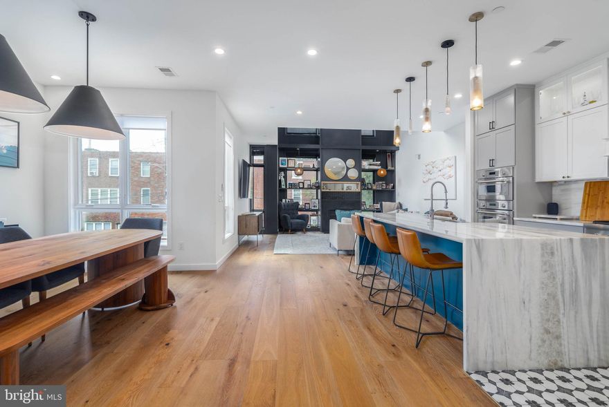 A Home Buyer is often left with tough decisions to make during their house hunt. Can we live without parking? Is the home too narrow? Can we live without a backyard? All of these questions and concerns can be left at the door of 2055 E Dauphin. Welcome to the Unicorn of Fishtown. Located on a massive 27' by 85' lot, this custom-built home was envisioned by GNOME architects and designed by rj lowercase. Square footage is no problem here - over 4,200 sqft of interior space spans the wide-open floor plan. Comfortably park in your GARAGE or driveway and enter this gorgeous foyer outfitted with chevron pattern brick floors and timeless trim work. The rear of your first floor includes a beautifully appointed office or bedroom with access to a full bathroom. The lower level is primed for entertainment - with MASSIVE 12' ceilings, this space is enormous for game days, movie nights or even your at home golf simulator (wiring already set up for projector!). This level is also decked out with a bar, wine room, and a special surprise you just have to see.  The 2nd floor is truly special. A custom chef's kitchen with the highest level of appliances centers the area, but the 2 story living room is the cherry on top. Incredible light fills this space and on cold days, enjoys the gas fireplace. It is the perfect four-season room. The floor is emphasized with another bedroom, bathroom, and a large outdoor patio - perfect for grilling and dining. The third floor of your designer home features a secondary bedroom bathroom, and laundry. But then you walk into your gorgeous primary suite and you may feel you have walked into an exclusive five star hotel. Adorned by a beautiful trim work and colors, this space includes 2 large walk-in closets and a magazine-worthy bathroom suite. Best for last, the outdoor spaces at 2055 Dauphin are a standout - no need to move to the suburbs to get the land you want! The rear yard is MASSIVE with beautiful greenery and turf grass - perfect for four-legged fur friends or kids. The roof top deck features multiple seating areas with center city skyline views. All these features in this home only STEPS away from Frankford Ave. There truly is too much to list for 2055 E Dauphin. Schedule your private tour today!