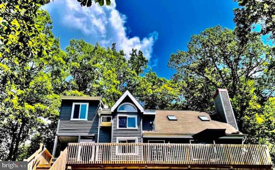 SKI-IN/SKI-OUT LOCATION, LOCATION, LOCATION, ACTIVE TRANSFERABLE SHORT TERM RENTAL PERMIT*** This 3 Bedroom, 2 Bathroom Contemporary Home is perfectly situated right off the ski lift and slopes in the amenity-filled Saw Creek Estates of Bushkill, PA. Step inside to discover an open-concept layout with a vaulted ceiling living room featuring a cozy fireplace, ideal for après-ski relaxation. The home offers a loft area for a secondary family room, a 4-season room with electric fireplace insert, and a screened-in porch for year-round enjoyment. Enjoy the full lifestyle experience of Saw Creek Estates, including indoor/outdoor pools, a fitness center, tennis courts, 24-hour security, skiing, and so much more. Whether you're seeking a mountain getaway or a full-time residence, this home delivers comfort, convenience, and adventure at your doorstep.