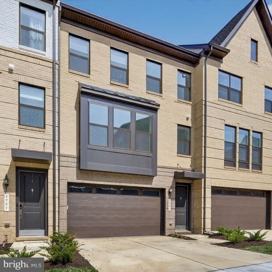 Tucked within the sought-after Boulevards at Westfields, this nearly new 2024 townhome offers a refined blend of modern design, comfort, and effortless living across three beautifully appointed levels.

Upon entry, a spacious two-car garage is complemented by a versatile lounge or recreation room—ideal as a home office, media space, or guest retreat—complete with a convenient half bath and additional storage.

A short ascent leads to the heart of the home, where an open-concept main level is bathed in natural light. The expansive living and dining areas flow seamlessly into a stunning kitchen, featuring striking black subway tile, warm-toned cabinetry, and a bright, airy ambiance that feels both contemporary and inviting. Perfectly positioned mid-row with no direct homes in front, the residence enjoys an abundance of natural sunlight throughout the day. A private deck extends the living space outdoors—ideal for entertaining or relaxed evenings of grilling.

The upper level is thoughtfully designed for both comfort and functionality, highlighted by a serene primary suite with a walk-in closet and a well-appointed en-suite bath. Two additional bedrooms, a full hall bath, and a conveniently located laundry room complete this level.

Enhancing the home’s modern appeal are smart features including an integrated speaker system and select motorized shades, both easily controlled from your phone.

Stylish, sun-filled, and exceptionally well maintained, this residence presents a rare opportunity to own a truly turnkey home in one of Chantilly’s most desirable communities.