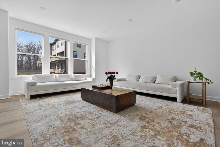 Tucked within the sought-after Boulevards at Westfields, this nearly new 2024 townhome offers a refined blend of modern design, comfort, and effortless living across three beautifully appointed levels.

Upon entry, a spacious two-car garage is complemented by a versatile lounge or recreation room—ideal as a home office, media space, or guest retreat—complete with a convenient half bath and additional storage.

A short ascent leads to the heart of the home, where an open-concept main level is bathed in natural light. The expansive living and dining areas flow seamlessly into a stunning kitchen, featuring striking black subway tile, warm-toned cabinetry, and a bright, airy ambiance that feels both contemporary and inviting. Perfectly positioned mid-row with no direct homes in front, the residence enjoys an abundance of natural sunlight throughout the day. A private deck extends the living space outdoors—ideal for entertaining or relaxed evenings of grilling.

The upper level is thoughtfully designed for both comfort and functionality, highlighted by a serene primary suite with a walk-in closet and a well-appointed en-suite bath. Two additional bedrooms, a full hall bath, and a conveniently located laundry room complete this level.

Enhancing the home’s modern appeal are smart features including an integrated speaker system and select motorized shades, both easily controlled from your phone.

Stylish, sun-filled, and exceptionally well maintained, this residence presents a rare opportunity to own a truly turnkey home in one of Chantilly’s most desirable communities.