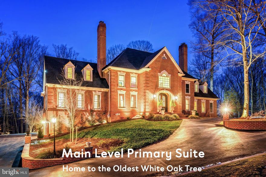 Perched on a private knoll within the prestigious Southdown enclave of Great Falls, this extraordinary custom estate commands five acres of manicured and wooded grounds backing to protected parkland with seasonal Potomac River views and direct trail access from your own backyard. A singular offering anchored by one of the oldest and largest white oak trees in all of Great Falls, a living landmark predating the Civil War.

Inside, soaring ceilings, bespoke millwork, and six fireplaces set a tone that is at once grand and deeply residential. The brand-new designer kitchen flows seamlessly into the expansive family room, while the main-level primary suite provides a true sanctuary with a spa-appointed bath and an exceptional custom dressing room. The walk-out lower level is an estate unto itself, boasting a custom bar, private gym, sauna, wine cellar, and gracious guest accommodations.

Beyond the walls, a private resort awaits: a heated saltwater pool and spa, a pool house, and mature, cathedral-canopied grounds that offer both beauty and absolute seclusion. Equestrian-friendly acreage, a new roof, Andersen windows, tankless water heaters, and home generator coverage complete an already impeccable package.

Ultimate privacy. Irreplaceable natural beauty. And the ease of being minutes from the city — with everything already here. A resort-style living awaits you.