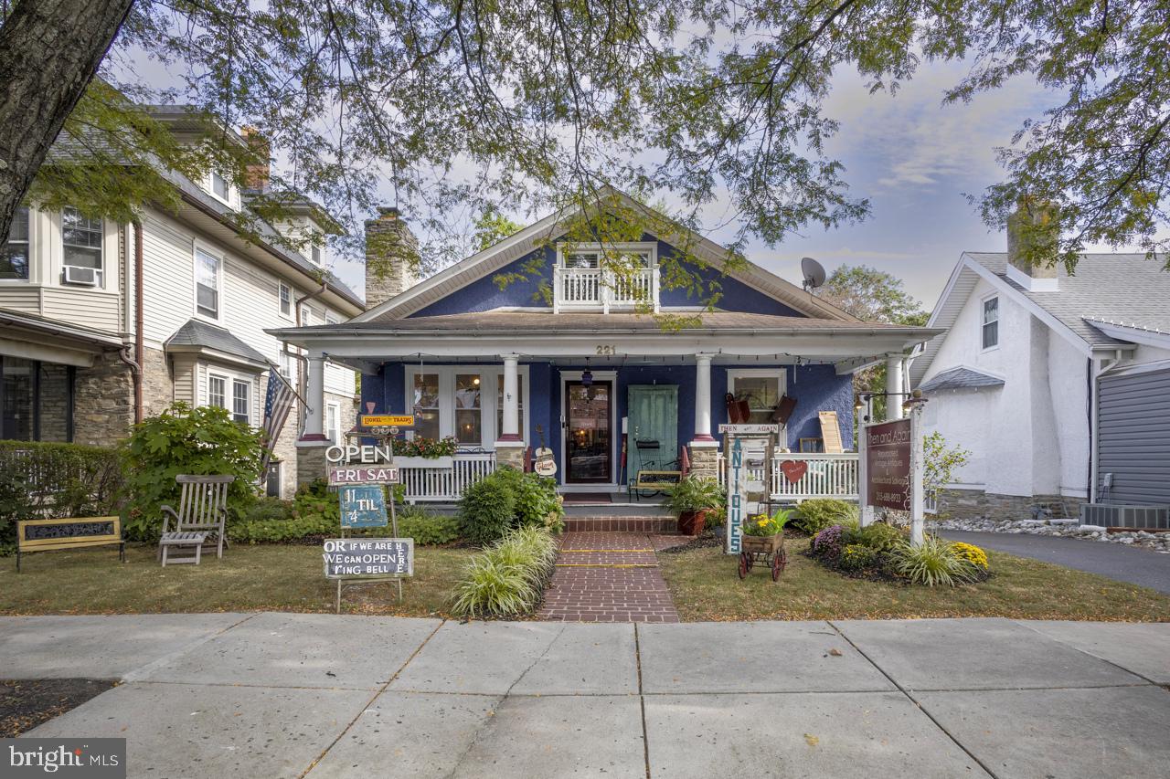 Welcome to 221 S Easton Road, a property where character and opportunity meet in the heart of Glenside.
This distinctive bungalow, with its broad-covered porch and classic lines, offers more than just curb appeal. Zoned MU1 and blending both character and versatility, this mixed-use property offers the flexibility you’ve been looking for. The designation allows for a single residential unit as well as a range of commercial possibilities—whether as a retail shop, creative studio, or client-facing office with the convenience of a “short commute” and clear separation from the living quarters behind. Throughout the home, beautifully refinished wood floors and natural wood doors with crystal knobs add warmth and timeless character, enhancing both the commercial and residential spaces.
The front commercial space, currently configured as a welcoming storefront, features a stone fireplace with a Dimplex insert and plenty of natural light. Step beyond its doors and into the delightful residential portion of the home, where thoughtful updates meet enduring charm.
The kitchen makes an immediate impression with quartz counters, a marble-topped island, farmhouse sink with garden views, pantry storage, and a stacked washer/dryer. The kitchen opens to a cozy sitting room with custom built-ins and a second Dimplex fireplace. The main floor bedroom offers two closets and sits just steps from a tastefully updated full bath featuring updated fixtures, wainscoting, and a shower-over-tub.
Upstairs, two more bedrooms, a full bath with stall shower, a kitchenette, and plentiful storage make the second floor ideal for extended living space, a rental, or private quarters.
The basement, a woodworker’s dream, offers a sprawling workshop, office, and storage areas, complete with its own restroom and dual access from the kitchen or the rear walkout.
Outdoor living extends the home’s appeal, with a partially covered deck overlooking a fish and frog pond, plus a hammock and bench to enjoy the garden setting. A wide driveway accommodates 3–4 cars, while the detached two-car garage with barn-style doors and a manageable lawn wrapping behind complete the picture.
Situated in the heart of Glenside’s business district, this mixed-use property enjoys steady foot and car traffic with plenty of business and bustle out front while providing a peaceful and secluded retreat in the residence and out back. Renninger Park, Glenside Memorial Hall, and the community pool are just around the corner, and a wealth of dining and shopping options are within easy reach—along with the Glenside train station just three blocks away.
Whether you envision an investment property, a new home for your business, or a place where you can truly live and work with ease, 221 S Easton Road is ready to meet you there.