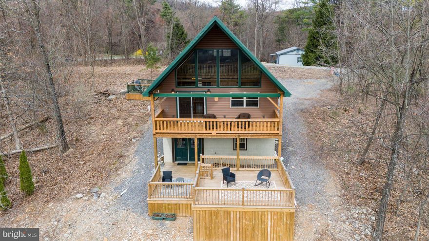 Your private retreat awaits! Escape to this charming cabin, nestled away on 1.82 Acres with breathtaking views in every direction. This property offers the ultimate sanctuary where you can unwind and embrace nature's beauty.

As you enter, you'll be welcomed by stunning hardwood floors and a spacious kitchen perfect for cooking and dining. The open floor plan features towering vaulted ceilings and oversized windows that frame stunning views all around. The large living area, complete with a cozy fireplace, is perfect for relaxing by the fire, while sliding glass doors lead to a generous deck that extends your living space outdoors, ideal for enjoying the scenery year-round.

On the main level, you'll find a full bathroom complete with a tub and a cozy bedroom, providing comfort and convenience. The upper level loft offers versatile space that could be used as another living area, bedroom, or studio—endless possibilities to suit your lifestyle.

The walk-out basement, currently unfinished, opens up to a second expansive deck that overlooks the captivating views, offering even more space for relaxation or outdoor entertaining.

Whether you're seeking a peaceful retreat, a 2nd residence, or a vacation getaway, this cabin provides the perfect setting. Juniata river front access and close commute to Lewistown and amenities.   Don’t miss the opportunity to own this slice of paradise!