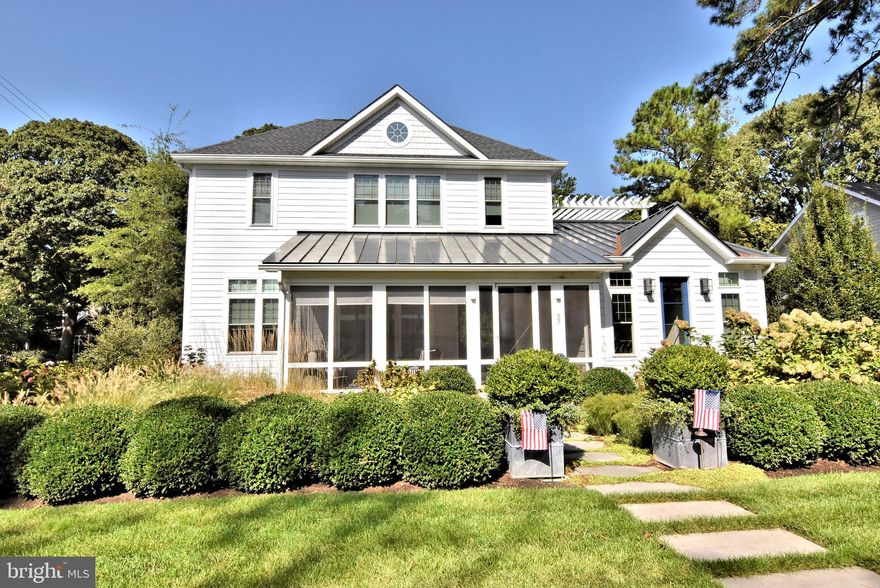 Just 2 blocks to the beach, this upscale coastal contemporary home features all of the quality and appointments one expects in a luxury home! Situated on a 75x 100 corner lot, this home has 6 ensuite BRs, with 2 on the first floor.  The first floor features a custom designed kitchen featuring quartz counters, Sub-Zero and Miele appliances, beverage drawer, wine fridge lighted liquor cabinet, detached ice maker and a huge island.  10 foot + coffered ceilings and 8-foot solid core doors give the home elegance.  The TV is hidden when entertaining by lowering the panel. There is a built-in sound system, discreet recessed lighting throughout the home, as well as beautiful hardwood floors in all living areas and BRs, tiled floors in all baths.   The first floor Primary BR is spacious and elegant, with a fireplace, luxury bath and large walk-in closet.  There is also a 2nd ensuite BR on the first floor, as well as a laundry room and half bath.  The 2nd level offers 9-foot ceilings, 4 large ensuite BRs, a second laundry, wet bar, and pergola covered lounging deck overlooking the pool.  The basement has a large, finished area, as well as a full-sized wine fridge and secondary refrigerator.  The crawl space area has concrete floor and is fully conditioned.  2x6 exterior walls and Hardi-Board type siding for low maintenance.   Enjoy your summer afternoons lounging around the Hampton's style 12 x  24 pool!  The home is being offered fully furnished (excluding art and contents of cabinets) so you can move right in.   This home has been gently used and shows "like-new".  Put this home on your list of "must-see" homes, I promise you won't be disappointed!