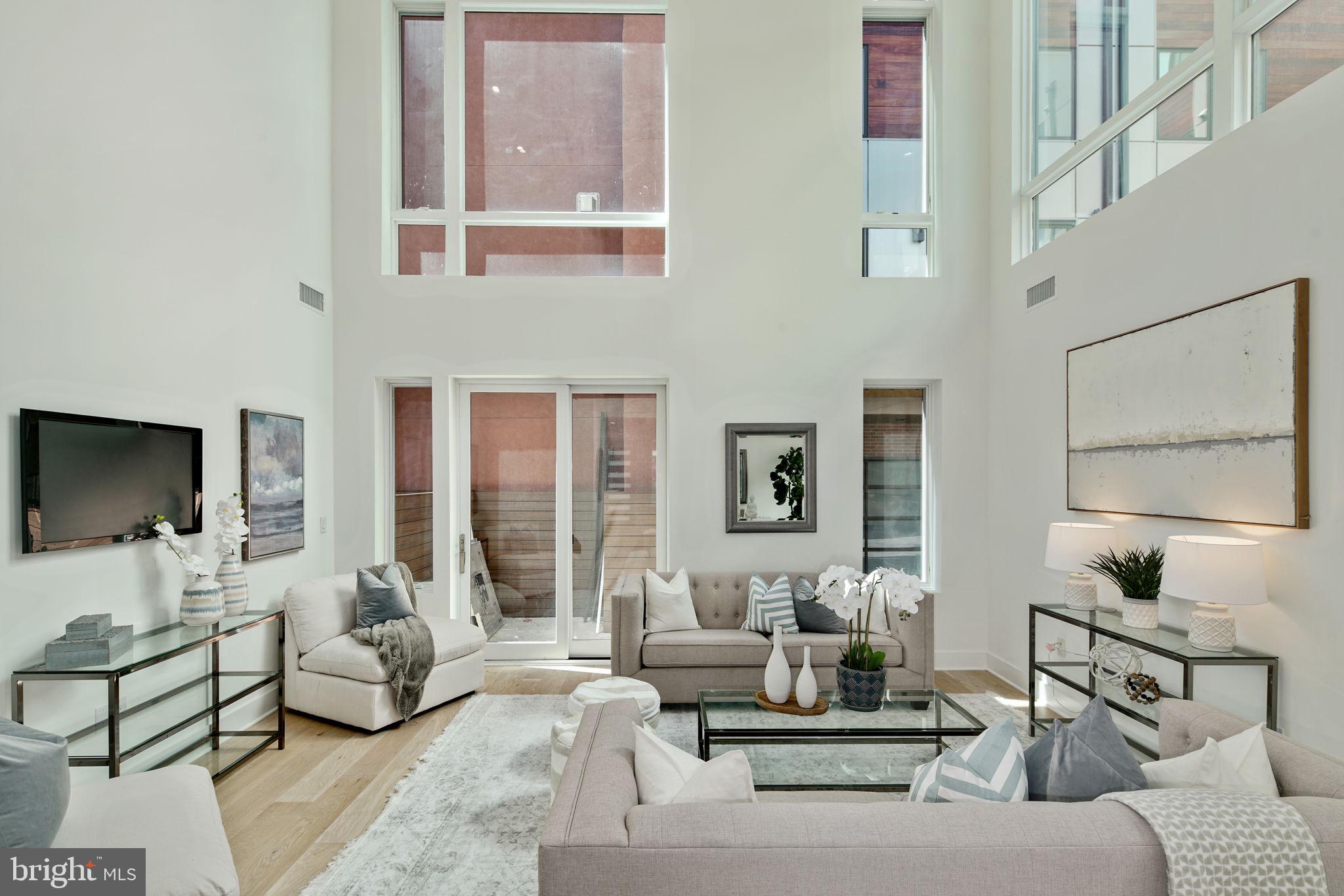 NEW CORNER HOME that has never been lived in, in Society Hill at the city's most prestigious location. The owner is in the process of installing blinds on every window in the house, tax abatement ( 7 years left), 2-car parking, 6 stop residential elevator, Roof Deck and rear yard, 5 bedrooms, 4 full baths and 2 half bathrooms, possible 6th bedroom layout available. Finished basement with media room. Energy efficient dual HVAC systems, Security alarm and Video intercom system, Control-4 home automation system, 8' solid core interior doors, custom staircases, walk in closets, Luxurious Marvin windows, Toto toilets, and Grohe fixtures just to name a few amenities . This Custom home is an ENERGY STAR qualified new home. The kitchen has WOLF and sub-zero appliances, stone counters, custom cabinets and amazing back-splash options. This corner unit has massive windows that drench every room with natural sunlight. Located steps away from Philadelphia's waterfront at Walnut Street and the soon to be expanded several hundred million dollar Penn's Landing Park. Penn's Landing park will be several acres of green spaces and direct access to the waterfront. Live in the center of it all! Walk to theaters and countless restaurants. Live the ultimate urban lifestyle at Adagio. Photos are of other homes built by the developer. Come walk the floor plan and marvel at the wonderful layout. Square footage total includes above grade space and below grade space and is estimated. It is the responsibility of the buyer to verify square footage and taxes. HOA fee does not include flat rate for monthly PRIVATE water $65.79.