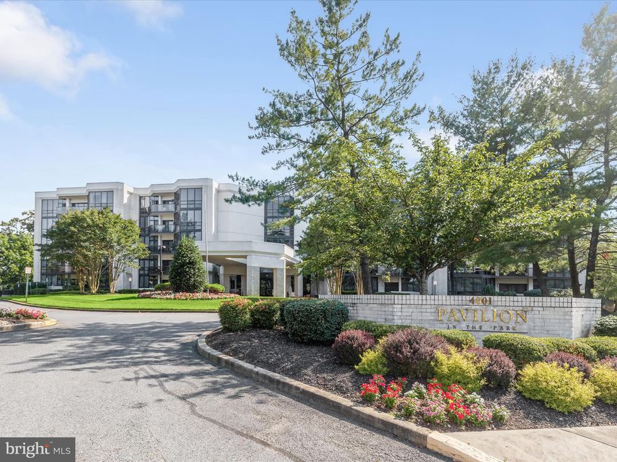 Introducing this exceptional second-floor condo in the sought-after Pavilion In The Park, offering two bedrooms with two-full and one-half bathrooms, and two balconies. Featuring over 2,500 square feet of living space, this home is filled with an abundance of natural light from floor-to-ceiling windows and glass doors. The interior is graced with spectacular details throughout including crown molding, chair railing, wainscotting, dimmable lighting, parquet hardwood floors, and more. Enter inside the unit where the foyer welcomes you with marble floors and two hidden closets. Prepare your favorite meals in the gourmet eat-in kitchen that showcases granite counters with a waterfall island, space for a breakfast table, and 42” soft- close cabinets with lazy Susans, slide-out drawers, and organizers. The kitchen is also equipped with stainless steel appliances including an induction cooktop, range hood, beverage fridge, and built-in wall oven and microwave. Entertain guests in the elegant dining room, while the expansive living room has space for any size gathering. A cozy den provides a lounge space that is perfect for kicking up your feet and watching your favorite movies. The office is another versatile space, complete with built-in cabinets for private work at home. Indulge in the luxury of the primary bedroom suite that boasts two walk-in closets with organizers and a balcony shared with the second bedroom. The exquisite en-suite primary bathroom highlights a dual-sink vanity with built-in lighting, a large jetted tub, and a frameless walk-in shower with a bench. Down the hall, are the second bedroom and bathroom with a tiled-tub shower and two linen closets. Enjoy spending time outside relaxing or dining, with two private balconies. Completing this remarkable condo are a half bathroom and a laundry room with storage space. Additional features include an assigned garage parking space, and a secure lobby with a doorman. Located in Pikesville, this home is minutes from excellent shopping, dining, entertainment, and recreation, with quick access to Routes 695, 795, and 83. Some images have been virtually staged.