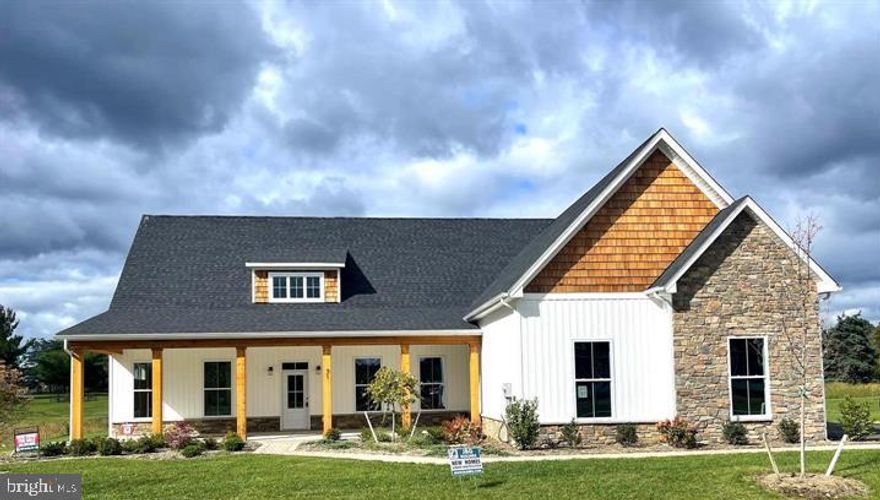 Welcome to the Estates at Edgemoor! This luxurious community offers dazzling, upscale home styles with 1 acre+ lots and are close to the VA line in Berkeley County. Open up your living space with the Camelia model a spacious 4,500+sqft, 5 bed, 4.5 bath rancher with wainscoting, an open concept floor plan, and 10ft ceilings on the main level. The kitchen shines with upgraded appliances, a Quartz island with a built in cabinet microwave, double ovens, and touchscreen cooktop. The primary bedroom is on the main level and has access to a rear porch. The primary bath boasts a double door bathroom, with huge walk-in double shower, soaking tub, and ceramic tile flooring. You will want to snuggle up with a good book in front of the gas fireplace in the 14x16 sunroom - which has access to both rear porches with ample entertaining space! 

The upper level of the home is just as large as the main level! There are an additional two bedrooms with their own bath. Entering the upper level, you will find a rec room with wet bar, a storage room, and a quiet sitting area. 

Other features include recessed lighting throughout the entire home, crown molding, and LVP flooring. On the exterior there are cedar shaker shingles, stone work, 3 car side loading garage, and a 12x40 front porch. Windows line every inch of this home so let the natural light flow through! Schedule your showing today to see what our newest community has to offer!