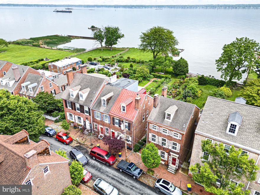 Experience timeless elegance & stunning river views from the comfort of your own home ***13 The Strand—an extraordinary historic home nestled along one of Historic New Castle’s most iconic and scenic streets! This beautifully updated residence offers the perfect blend of 19th-century charm with thoughtful modern upgrades *** including a new High Efficiency Gas Combi Boiler & Tankless Water heater. High ceilings, original wide plank floors, & historical architectural details are found throughout. Enter an elegant front foyer to a spacious living room which flows seamlessly into the formal dining room. Next is the Gourmet Chef’s Kitchen (a true showstopper) with granite countertops, a spacious island, maple & cherry cabinets. Its sitting area has a PANORAMIC wall of windows with stunning views of the garden & the Delaware River. The 2nd-floor Primary Suite features high ceilings, ample built-in storage, and a decorative fireplace. The spa-like bathroom is complete with ceramic tile walk-in shower, soaking tub, a custom-built vanity with granite counter tops, and plenty of storage. Also on the 2nd level is a library/office with a full wall of river-facing windows. The 3rd floor offers two additional bedrooms, a shared full bath, and cedar closet. The garden level en-suite features built-in wood shelving and a full bath with a step-in shower. The en-suite extends to the adjacent room which features original deep-silled windows and shutters set into a stone wall, and antique brick flooring. Off the brick patio a winding path leads you through three garden “rooms” with shrubs and perennials, many native to the Mid-Atlantic region. At river’s edge mature plantings surround a bluestone dining patio, providing a private space to enjoy river views. Walk down The Strand for easy access to New Castle’s historic museums, William Penn’s historical plaque and statue, the First State National Historical Park’s Welcome Center, and many restaurants and shops. Delaware’s Tall Ship the Kalmar Nyckel docks at the nearby wharf in season, and the Battery Park Trail wends from there south along the river. Community-organized events such as May Market, A Day in Old New Castle, Separation Day, and Spirit of Christmas provide numerous ways to explore and participate in celebrating the town. This is a truly unique opportunity to own a piece of Delaware’s history—with views, space, and a setting that’s simply unmatched.