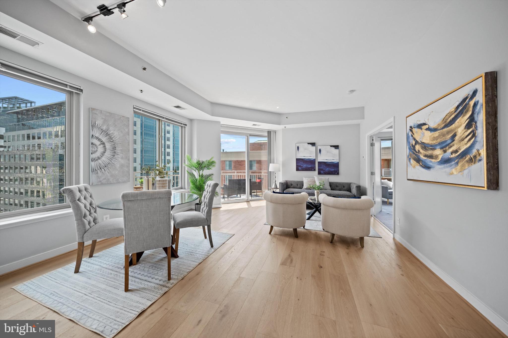Experience the epitome of urban living at this exceptional 3-bedroom penthouse, perfectly positioned in the heart of downtown Bethesda. Nestled between Bethesda Row and Woodmont Triangle, this rare top-floor residence offers an ideal combination of light, space, and convenience in one of the area’s most sought-after locations.
Bright and sunny with 10’ ceilings and brand new 7" wide plank white oak hardwood floors, the open concept living area flows seamlessly to an oversized balcony, where sweeping views of downtown Bethesda provide a splendid urban backdrop. Overlooking the living space, the gourmet kitchen is beautifully appointed with granite countertops, maple cabinetry, and stainless-steel appliances—offering both functionality and style.
The expansive primary suite serves as a private retreat, complete with a generous walk-in closet and spa-like ensuite bath. Two additional bedrooms offer ample closet space and share a well-appointed bath, with one bedroom enjoying direct access. Additional conveniences include in-unit washer/dryer, two assigned garage parking spaces, and two storage units.
Beyond your doorstep, experience the best of Bethesda with world-class dining, boutique shopping, and vibrant cultural attractions just steps away. The Chase at Bethesda offers exceptional amenities, including an outdoor swimming pool with hot tub, two lit tennis courts, grilling area, and 24-hour concierge—all directly across from Metro for unmatched accessibility.