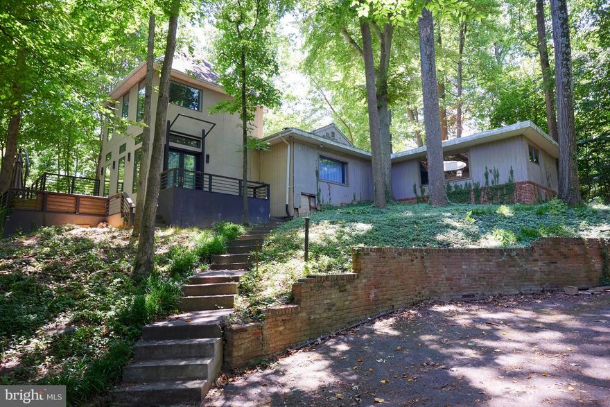 *HUGE PRICE DROP!* 
Discover your private, secluded retreat on a sprawling over 0.5-acre lot, overlooking the serene beauty of Sligo Creek in highly sought-after Takoma Park. This exceptional property presents a rare opportunity to customize and craft your dream home in a stunning wooded setting. Embrace the tranquility and natural allure of the surroundings as you bring your vision to life in this captivating oasis.

The home, originally built in 1961 and expanded several times since, has amazing potential but needs your final touches. Fourth bedroom needs full reno but has brick fireplace, huge windows facing woods & creek, and a dome skylight.