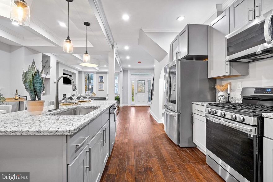 Huge price reduction on purchase price for the holiday! Come and visit this Beautiful, fully renovated townhouse in Baltimore City, featuring over 2000 sqft of living space. The main level features a custom ceilings, electric fireplace, new flooring throughout the house, recessed lights, a half bath and an open concept kitchen with new cabinets, granite countertops, backsplash and all new stainless-steel appliances! The upper level features a master suite and 2 additional bedrooms, and one hallway Full bath. This beautiful house has stylish finishing touches and modern fixtures. The basement is fully finished with a walkout exit and two additional bedrooms with a full bathroom. New HVAC system and ductwork, electricity and plumbing. Washer and dryer included. Nice backyard with 2 parking pad located in the rear of the house and a new deck. Don't miss the opportunity to make this stunning property your new home! Schedule you showing now!!