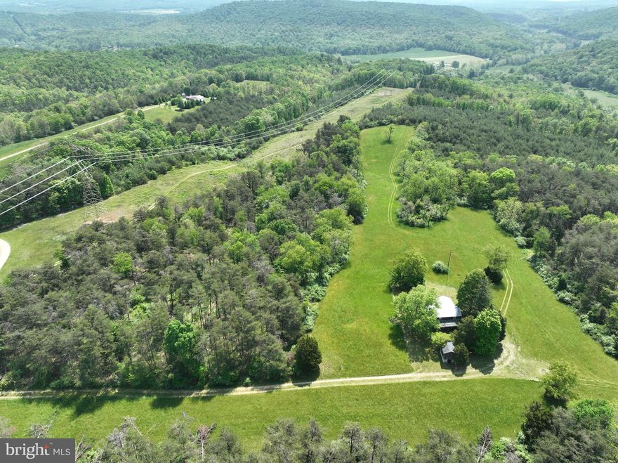 Farming for the generations. Create your own legacy with some of the finest land Hampshire County, WV has to offer. Absolutely ideal for farming, equestrian, hunting, shooting or simply just an escape from city life. Completely UNRESTRCITED, the property spans 153.10 +/- acres with excellent road access, over 800’ of frontage on the Little Cacapon River and a small pond begging for expansion. Easy rolling topography makes most any use easy to accommodate.  Improved with a rock-solid Farmhouse providing turn-key useableness while you make plans for the perfect estate home. Towering hardwoods, beautiful pines and views as far as you can see make this an easy decision. Offerings like this are truly rare. Change the direction of your life today. Easy access from the Farm to the Capital in less than 2 hours.