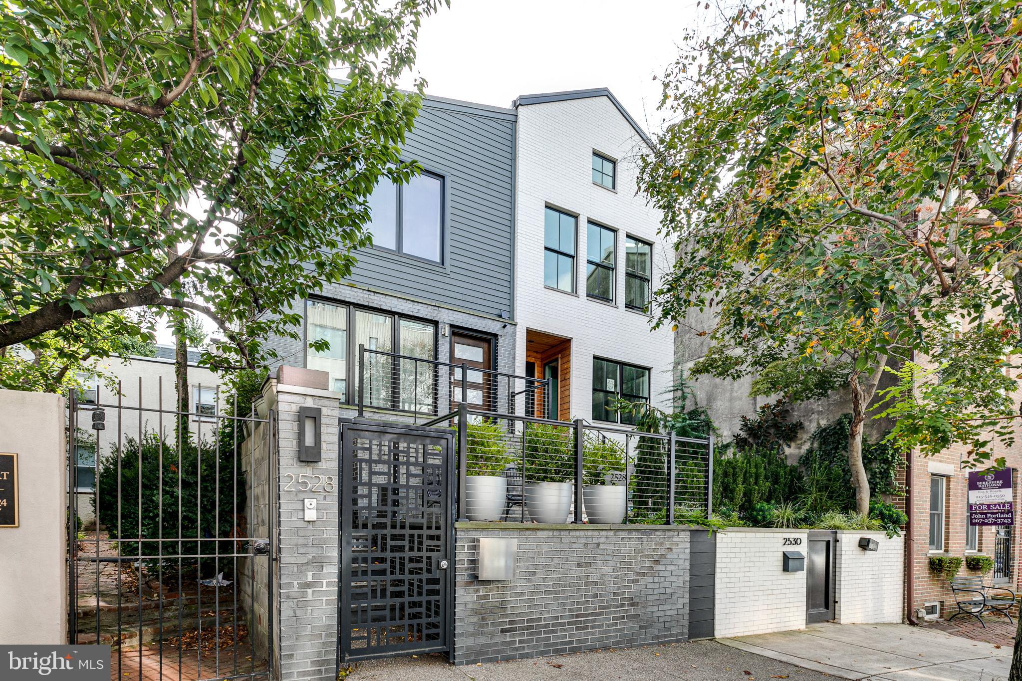 Welcome to 2528 Pine Street in Fitler Square. This reimagined 3 bedroom townhouse with garage parking sits on a 24x84 ft lot offering a setback respite from the street. A private gate leads you through the front garden area and patio to the front stairs and entryway. The main living space is flooded with natural light with windows on 3 sides with exposures to the south, east & north and features white oak wood flooring and high ceilings. The living room and dining room are open and complete with a wood-burning fireplace with a marble mantle and a built-in bar. Adjacent to the dining room is the eat-in kitchen with marble counters and backsplash, high-end appliances including a vented hood over the six-burner range, and custom cabinets. The primary bedroom on the top level is absolutely stunning with high ceilings and a picture window with tree-top and skyline views, plus a wall of outfitted closets. The primary bathroom is en-suite featuring marble tile, a large pedestal sink and a seamless glass enclosed shower. A mirrored door conceals the conveniently located laundry room with a full-size washer & dryer plus additional storage. Also located on the top floor of the second bedroom plus a beautiful hall bathroom with a tub/shower combo and oversized single vanity. The lower level of this property is at garden level and is complete with another spacious bedroom, family room, full bathroom with a stall shower and access to the mudroom and garage. The back of the property is a large private patio with custom planters and a semi-private driveway. 2528 Pine Street is located in the heart of the Fitler Square neighborhood and directly adjacent to the Schuylkill River Park which includes the community tennis courts, jogging/biking/walking trails, dog park, community garden and Markward playground. Within a few blocks you'll find local shops like Rowhome coffee, Rival Bros, Coteletta, Sally and Trattoria Carina as well as conveniences like South Square Market, Heirloom Market, CVS & more. This property is a short commute to CHOP, Penn, HUP, Drexel and 30th Street Station. You will love living here!