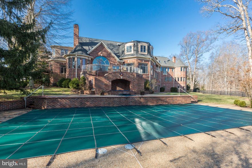 Exquisite gated estate on almost 5 acres with landscaped grounds that feature circular driveway,  pool & spa, tennis court, 5 stall barn with upper level office space and fenced paddock, screened in gazebo and 4 car garage with guest apartment on the upper level. This 13,000 square feet estate offers elegance in every room. An impressive 2- story marble foyer with a grand staircase welcomes you to the Reception, formal Living Room and Dining Room. The Library has built-in bookcases, wet bar and fireplace. The gourmet Kitchen in adorned with custom cabinetry, top-of-the-line appliances, wood-clad ceiling, huge walk-in Pantry and large windows that provide lots natural light. Continuing on the Main Level is the 2-story Great Room with built-ins, cathedral ceilings and stone fireplace, Main Level Bedroom with private bath and a In-Law Apartment complete with Kitchenette, Living Room, Bedroom and Full Bath. In the Upper Level is the Master Suite with a fireplace, luxurious Bath with separate vanities, dual walk-in Master Closets, Sauna and a 4th Level Sitting Room with skylights. In addition there are two Ensuites, Laundry Room and Lounge with built in cabinets. The Walk-out Lower Level is a true entertainers dream with a Recreation Room with fireplace, Media Room, Wet Bar,  custom Wine Cellar, Bedroom Suite with Sitting Room and private entrance. This property has two entrances, the second entrance is 639 River Bend Road, Great Falls.