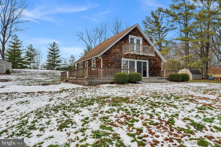 Set on nearly 2 flat acres in Union Bridge, this 3 bedroom, 2 full bath home offers a solid layout and plenty of potential for the right buyer. Cash or conventional financing only. Property is winterized. Privacy pines surround the lot creating seclusion and lovely views. Hardwood floors run throughout, and the main level features an open living and kitchen area, with the staircase creating natural separation. The living room includes sliding glass doors leading to the expansive deck. One bedroom with double closets and a full bath with tub/shower combo are located on the main level. Upstairs, you’ll find two additional bedrooms, including one with doors leading to a balcony, along with a second full bath featuring a walk-in shower and a hall closet. The basement includes a partially finished room and additional space for storage or future improvements. Outside, the long driveway provides ample off-street parking, along with a detached carport. With 1.76 acres, this property offers room to improve, expand, or reimagine the outdoor space. Sold as-is. A great opportunity for investors or buyers looking to add value in a Carroll County location.