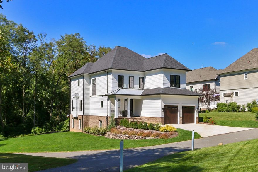 The beauty of this new home begins with its expertly trimmed and architecturally detailed HardiPlank® shake and lap exterior with a 2-car garage enclosed with wood-toned insulated doors, and professionally installed landscaping serviced by an underground irrigation system. The 8’ tall glass-paned Entry Door, complements the 9’ tall ceilings, and  STC rated Casement windows immerse this home with unlimited natural light.  Hand finished 4" wood plank floors flow through this expansive home filled with Meticulous Details.  Upgrades abound — including furniture quality custom Wood-Mode® kitchen and refined bath cabinetry and Upgraded Bath Fixtures, Hardware and Lighting Throughout this designer customized Luxury New Home.
Introducing an exciting Kitchen sure to inspire the enthusiastic chef with marble patterned quartz countertops, an exceptional brass-toned hood, and state of the art stainless appliances including a 36” Thermador® gas cooktop GE Monogram® Advantium and Convection ovens and a Bosch® French door refrigerator with Beverage Center complete this highly desirable space along with a large center island lighted with oversized pendants.  Wall sconces strike the perfect balance of ambience and illumination from day to night. The formal Dining Room echoes these fine details with a glass-icle chandelier adding an extra level of refinement.  The Bay Window Breakfast is ideal for daily dining overlooking the expansive natural area below. Adjacent is the Family Room with window wall leading to an outside decking area.  Recessed lighting, and a raised hearth Smart Gas fireplace with custom honed granite surround invite you to relax and enjoy your new home.  This amazing level includes a home office/study, a private Powder Room, and Mud Room leading to the fully dry-walled and painted garage to complete the main living space of this strikingly beautiful home.  ******
 Ascend the open riser staircase finished with squared Oak treads and continuous polished rail with contemporary metal balusters to the private upper Level. Here warm hardwood floors continue into the gracious Primary Suite complete with a Bay window sitting area, crisp crown molding, a 6 light chandelier, recessed lighting, and two well-proportioned walk-in closets with built-ins. The luxurious En-suite Bath offers separate 36” high Quartz-topped vanities with drawers, a freestanding Kohler® soaking tub with a floor mounted bath filler and hand shower, and a custom height frame-less glass-enclosed shower features both an overhead, and a hand-held spray.  This private level includes three (3) additional bright, well-proportioned and lushly carpeted bedrooms, generous closet space, and open to private or adjoining sparkling and fully upgraded baths; the laundry comes with Wood-mode cabinets and built-ins with a deep stainless sink. Situated across the hall is a wide linen closet perfectly sized for all household needs.
                                                                                                                         *****
The expansive Walk-Out lower level with premium textured carpeting, recessed lighting and built-in contemporary cabinets delivers great space for media, games, and exercise. Full view glass doors are your access for ease of moving to and from the open space of your rear and side yards!  Returning inside, a 5th bedroom with an oversized closet and a beautifully appointed bath with tub/shower creates guest quarters with the comfort and luxury found throughout this stunning home.
 
Close to I-95 & I-395, The Capital Beltway, Fairfax County Parkway, and Braddock Rd. with its direct access to HOT lanes as well as easy access to Bus and the Burke Centre and Rolling Rd. VRE stations. Outdoor enthusiasts enjoy the many area parks including Lake Braddock, Burke Lake Park with 888 acres of natural beauty surrounding a sparkling 218-acre lake and The Liberty Bell Trail for hiking and biking.