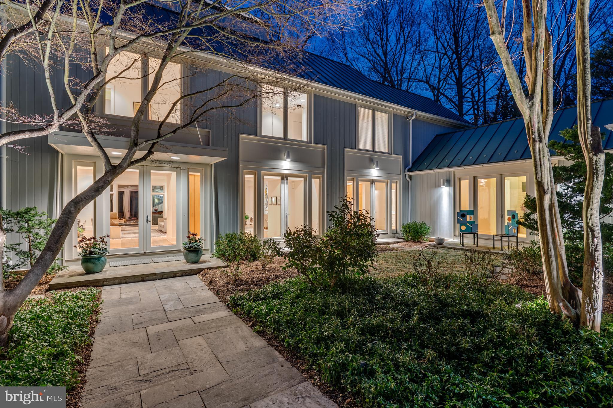 BY APPOINTMENT starting Saturday, March 19th please call Nancy.
***Offers due Monday, March 28th -5pm to WFP. Seller will review offers on Tuesday, March 29th.********
A once in a lifetime opportunity to own a Stephen Muse architectural masterpiece. This captivating contemporary residence is timeless in its design. High ceilings, floor to ceiling windows and breathtaking views of Rock Creek Park’s Soapstone Valley are just some of the special features found throughout. Designed to allow picturesque scenery from the inside out, and wall space that flatters a multitude of art. Designer lighting is found throughout along with lighting fixtures that are works of art unto themselves. An outdoor deck that spans the entire width of the home offers additional entertaining space. Warm and inviting, this floorplan welcomes you with ease and offers spacious formal rooms that flow from one to another effortlessly. A charming stone walkway leads to the main entry doors through a beautifully landscaped interior courtyard. The front doors open to a gallery entrance with a curving staircase along the far wall and an upper hallway gallery overlook. A spacious living room with fireplace opens to the dining room and flows easily into the eat in gourmet kitchen with center island. The far right side of the house was designed with a flexible library/office/additional bedroom alternatively used as a fourth bedroom. Wide hallways lead to the large spacious laundry and separate mudroom and provide easy access to the attached oversized two car garage. The upper level with gallery overlook provides three spacious bedrooms each with ensuite bath. The owners suite is the largest of these three with ample closets and a spacious light filled primary bath. All three upper level bedrooms overlook the grand views of Soapstone Valley. The lower level currently is currently designed as a recreation room and gym, and leads to a major unfinished area used for art and storage by the current owners. This additional space has plans for two more bedrooms, a library/office and another full bath. Welcome home to this enchanting contemporary home, filled with warmth and views of the outside in from every room.