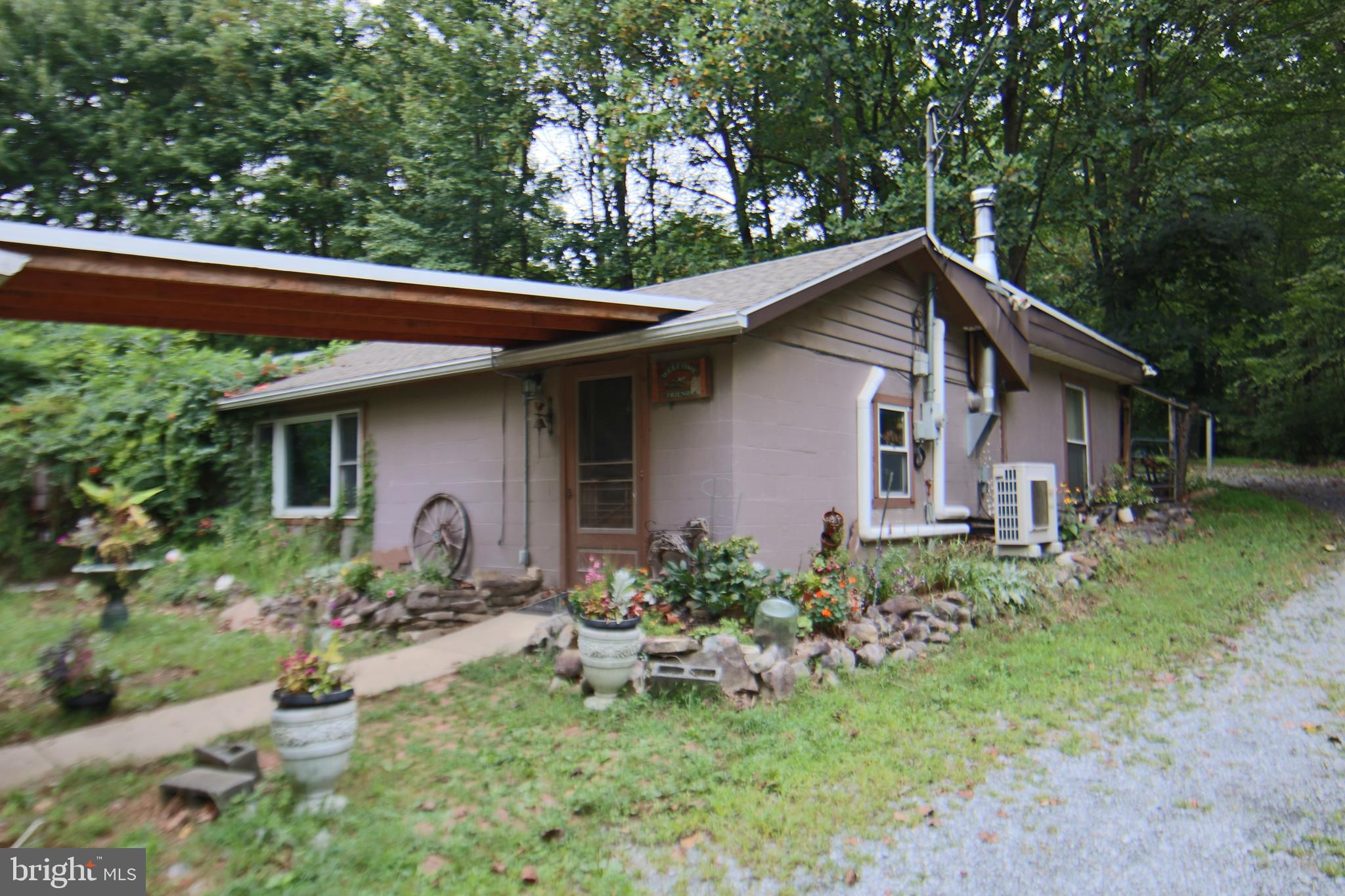 49 Acers of pure solitude and nature hidden from the world. Located in Grantville, East Hanover Township, Dauphin County on state route 443 and just minutes from I-83 making travel in all directions convenient. Total privacy without sacrificing convenience. Mature wooded parcel surrounded by wildlife and nature that will keep you constantly entertained. Two-bedroom ranch with gravel road access easy to get to even in bad weather. Large detached multi-purpose pavilion, 30’ x 80’ metal barn with five horse stalls, water, electric, tack room and feed storage area that is adjacent to pasture with metal panel livestock fencing and two turn out sheds for livestock or equipment. Ranch home with 1,300 square feet of living space one bath, two bedrooms, open kitchen, dining and living room, newer roof (2023), mini split heating and cooling (2017) and a wood stove that will heat the entire home with a lifetime supply of firewood gathered from the premise. Property enrolled in clean and green with super low real estate taxes. This is a wonderful opportunity to disconnect from the craziness and make this your own private world. Property is secluded and owner request that you please not enter the property without a confirmed appointment with a licensed realtor.