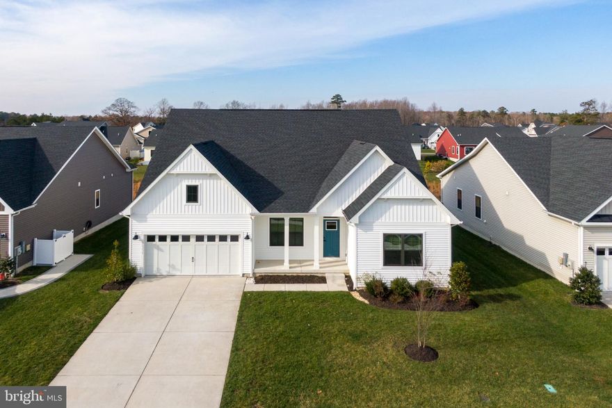 Welcome to 26230 Legacy Lane, a stunning 2022 built Savannah model that combines modern luxury with warm coastal-farmhouse character. Located in the highly desired community of Ocean Meadows in Lewes, this home is packed with thoughtful upgrades and offers the perfect blend of elegance, comfort, and functionality.
Step inside to a freshly painted home, bright, airy open-concept layout anchored by rich wood floors, upgraded lighting, and refined tray ceilings that elevate the home’s coastal style. The heart of the home is the gourmet kitchen, showcasing quartz countertops throughout, a spacious island, stainless steel appliances, and cabinetry that ties beautifully into the home’s fresh, beach-inspired palette.
Designed for convenience, the first-floor owner’s suite features a serene retreat with a spa-like bath and two generous walk-in closets. Two additional first-floor bedrooms provide versatility for guests, there is also a flex room that can be used as an office, music/reading or hobby space.
A standout feature of this home is the expanded second floor, offering a full fourth bedroom, full bathroom, additional living area, making it the perfect private getaway for guests, multi-generational living, or a second entertainment zone. 
Outside, enjoy peaceful mornings and evenings on your covered porch or patio, surrounded by the quiet charm of Ocean Meadows—a beautifully maintained community just minutes from Lewes’ beaches, dining, bike trails, and shopping.