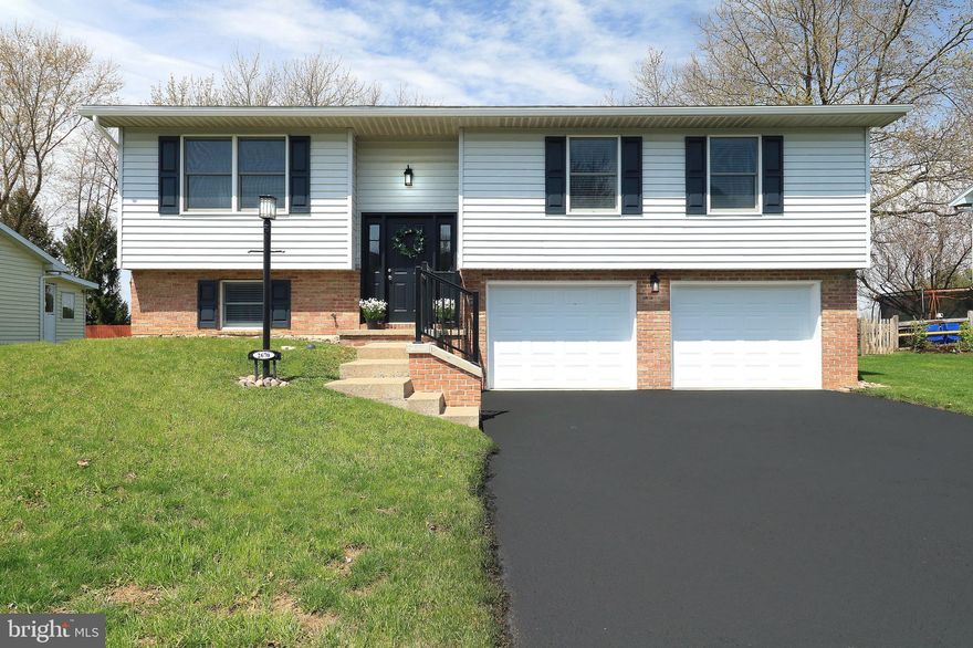 A Total Transformation in Penn Hills. Step into this stunning top-to-bottom remodel where fresh finishes, modern style & a central location come together effortlessly.  This truly move-in ready spilt-entry has been completely renewed for today’s lifestyle.  Step inside to be greeted by a freshly painted interior, beautifully refinished oak hardwood floors, all new chic light fixtures, recessed lighting & all new interior doors.  The open concept free flowing floorplan delivers a light-filled living room that effortlessly flows into a delightful dining area, where you can enjoy memorable meals.  The brand new sliding glass door leads to the composite deck with a white vinyl railing, perfect for relaxing as you take in the peaceful tree-lined backyard & endless views.  The kitchen shines with all-new stainless steel appliances, a classic subway tile backsplash, sleek granite countertops, black composite undermount sink featuring a double bowl design & a stylish gooseneck faucet.  The primary suite features 2 closets & a barn door leads you to the brand new full bath where you will find tile flooring, new dual vanity, toilet, light fixtures, mirror & tub with new tile surround.  There is an additional bedroom with 2 closets & it also delivers its own private all new full bath.  The finished walk-out lower level impresses with all-new luxury vinyl plank flooring, a spacious 3rd bedroom with an egress window & a large closet, newly added electric baseboard heaters, a beautifully renovated full bath with a walk-in shower & a laundry area complete with washer/dryer hookups plus a handy utility sink. Additional updates include a new electric heat pump, PEX & Manabloc plumbing system, electric water heater, new garage doors with openers, updated gutters & downspouts, new exterior light fixtures, black vinyl composite railing on the front steps guides you to the front door & a freshly sealed driveway.  Perfectly situated in the friendly Penn Hills neighborhood, you’ll love being just minutes from shopping, dining, Spring Creek Park, downtown State College & Penn State University. With quick access to I-99 & 322, commuting in any direction is effortless.  This completely remodeled gem is more than move-in ready, it’s Home Sweet Home in one of State College’s most convenient locations.