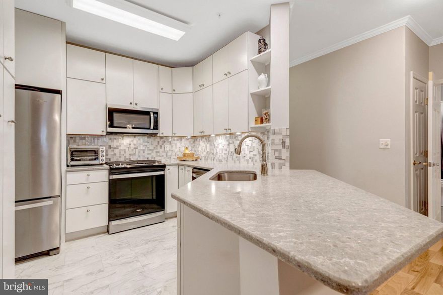 Welcome to this RENOVATED 2-bedroom, 2-bathroom condo offering the ease of true MAIN-LEVEL LIVING—no stairs required. Thoughtfully designed for both comfort and convenience, this home features a rare 1-car ATTACHED GARAGE along with an additional STORAGE UNIT. Inside, you’ll find a stunning 2022 renovation in both the kitchen and bathrooms, showcasing sleek quartz countertops, stainless steel appliances, and exceptional cabinetry with smart, creative storage solutions. Hardwood floors flow throughout the main living areas, while the second bedroom offers cozy carpeting. Relax by the gas fireplace or step outside to your private ground-level PATIO—perfect for morning coffee or evening unwinding. Enjoy access to fantastic community amenities, including a POOL, tennis courts, and fitness center. The building offers an elevator for ease of visiting neighbors. Ideally located in Fairfax, you’ll love the close proximity to shopping, dining, and major commuter routes, making everyday living effortless. Major systems are updated, HVAC 2021 and water heater 2024, offering added peace of mind. With its rare combination of true main-level access, extensive updates, and unbeatable convenience, this home is a true gem!