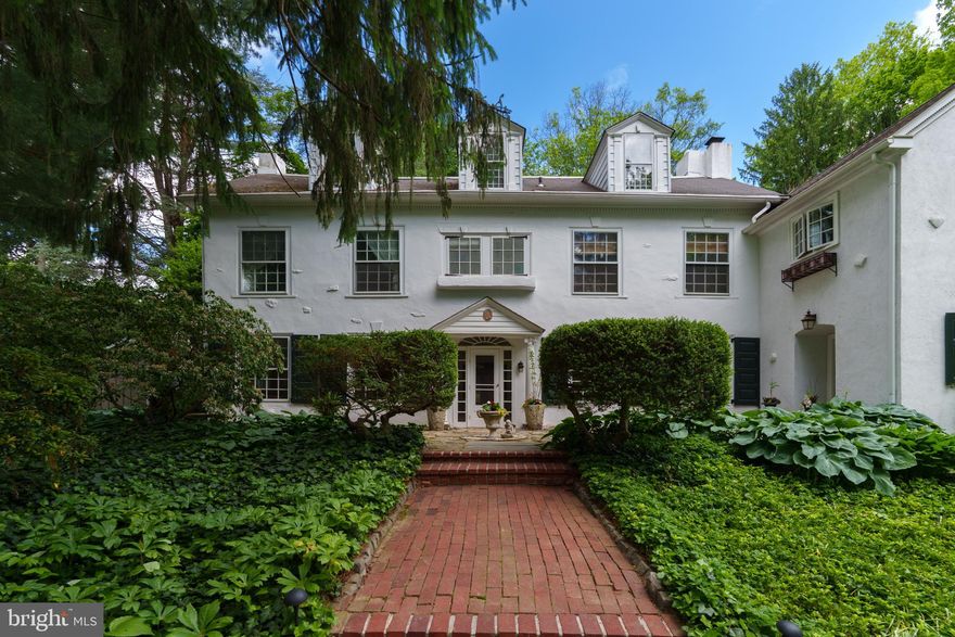Built in 1926 by Henry Price, 125 E Virginia Ave is a 5 bed, 4.5 bath home on the corner of Matlack and E Virginia that offers a special connection to the West Chester Borough community as well as a historical connection to Philadelphia. With a surrounding white fence and mature, lush landscaping that includes native rhododendrons and azaleas as well as rambling pink roses along the fence, this home offers unique curb appeal in the Borough and has been featured on Chester County Day and Christmas house tours multiple times. Architectural details include pieces that Price salvaged from homes in Philadelphia that were demolished during construction of the Ben Franklin Bridge in the early 1920’s and include oversized casement windows set horizontally and double hung, various fireplace mantles, crown moldings, built-in cabinets and millstones. Thoughtfully maintained and expanded, the home design presents a traditional, elegant feeling starting in the center hall entry and continuing into a beautifully blended 2004 addition that includes a large kitchen with a Rumford fireplace, breakfast room and mudroom. There are multiple built-in cabinets and shelving throughout, beautiful large windows, multiple large closets, a main entry hall, and a back staircase. There is a 2nd floor laundry room, conveniently located near the bedrooms, and there are 6 fireplaces including 3 woodburning on the 1st floor, a 2nd floor bedroom fireplace with a gas insert, and a beautiful (nonfunctioning) beehive fireplace in one of the bedrooms. This home also boasts a finished attic which is a lovely spot to set up a home theater or den and includes a full bathroom with a sauna. The walkout basement boasts a large open area that can be used as a game room, and also features a workshop and a dog wash station. Not to be outdone, the outdoor living spaces offer a place of retreat on the north side of the Borough, with a large private patio, garden, potting shed and a 2-car garage. Situated within easy walking distance to Marshall Square Park and all of the amenities that the Borough has to offer, 125 E Virginia Ave offers a graceful combination of home design, history and location. What a unique opportunity to be the next steward of this special property! Request a personal tour today.