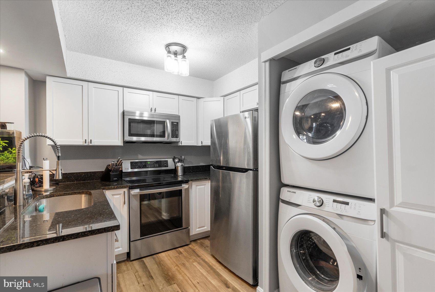 Discover comfortable and convenient living at 14105 William St Unit 15-C, nestled in the heart of Laurel, Maryland. This delightful third-floor condo offers a unique blend of space, light, and practical features, perfect for modern living. Step inside to find an inviting open-concept layout. The spacious kitchen flows seamlessly into a light-filled cathedral living room. Tall ceilings and abundant windows create an airy atmosphere, complemented by a cozy fireplace. This home boasts one bedroom plus a loft and one full bathroom. A versatile loft space, accessible via a staircase from the living room, provides an ideal home office or bonus area. Practicality meets convenience with a stacked washer/dryer set located off of the kitchen. Makes this awesome condo yours today!