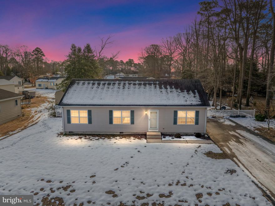 Discover coastal living in Warwick Park, a charming waterfront community of fewer than 200 homes tucked along the Indian River Bay. Residents enjoy access to approximately 4.5 acres of private bayfront amenities, including a gazebo and pavilion, picnic areas, crabbing piers, a boat launch, and floating docks with seasonal slip rentals (currently $575). It’s an ideal setting for kayaking, boating, and soaking in the peaceful waterfront lifestyle.

This well-maintained 3-bedroom, 2-bath off-site stick-built home features a desirable split floor plan, offering privacy with the primary suite on one side and two guest bedrooms on the other. The open-concept kitchen, dining, and living area is bright and inviting with electric fireplace, with a conveniently located laundry room just off the kitchen. Additional attic space provides ample storage.

One of the standout features is the new (2025) screened-in porch with adjoining sun deck, creating the perfect space for relaxing, entertaining, or enjoying the outdoors in comfort. The fully fenced backyard also includes a storage shed and offers plenty of room for outdoor activities.

Recent updates include a stove (2024), refrigerator (2022), hot water heater (2022), roof (2017), and HVAC (2013). An Apco-X air purifier with plasma ionizer was installed in 2024 to enhance indoor air quality, and a preventative termite treatment was completed in 2023. The septic system has been H-inspected and found satisfactory.

Warwick Park is part of Phase II of an approved sewer expansion, with Phase I construction beginning in 2025 and completion by Summer of 2028. The one-time discounted connection fee is waived, with an annual service fee of $330.

With owned land, low HOA fees of just $275 per year, bay access within walking distance, and convenient proximity to shopping, dining, and approximately 15 miles to Delaware beaches, this home offers an exceptional blend of affordability, community, and coastal lifestyle. Imagine strolling along the river’s edge, taking in the ever-changing landscape as the sun rises and sets, casting reflections across the water — a simple, peaceful ritual that makes everyday living feel like a retreat. Schedule your showing and explore the possibilities this lovely home has to offer.