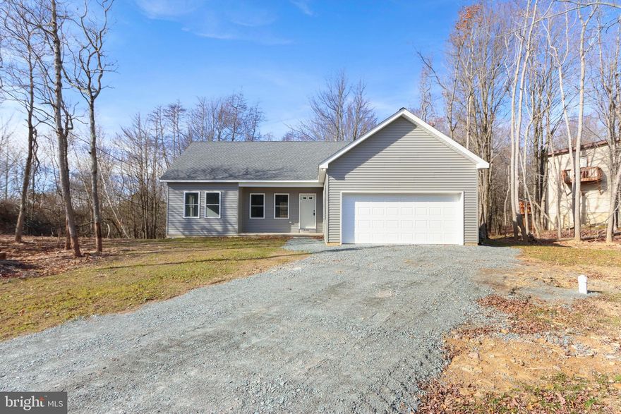 Looking for new construction without the wait? This newly built ranch delivers modern living from the moment you step inside. The bright, open-concept layout seamlessly connects the living room, dining area, and stylish kitchen—an ideal setting for everyday comfort and effortless entertaining. The main level offers two well-appointed bedrooms and two full baths, while the unfinished lower level with 9-foot ceilings provides incredible potential for expansion—perfect for a third bedroom, additional bath, or a full bonus suite. Enjoy seasonal lake views from the back deck along with community lake access, adding both lifestyle and value to this peaceful setting. Move-in-ready with contemporary finishes throughout. Ask how to receive up to $5,000 lender credit towards closing costs or lowering your interest rate!