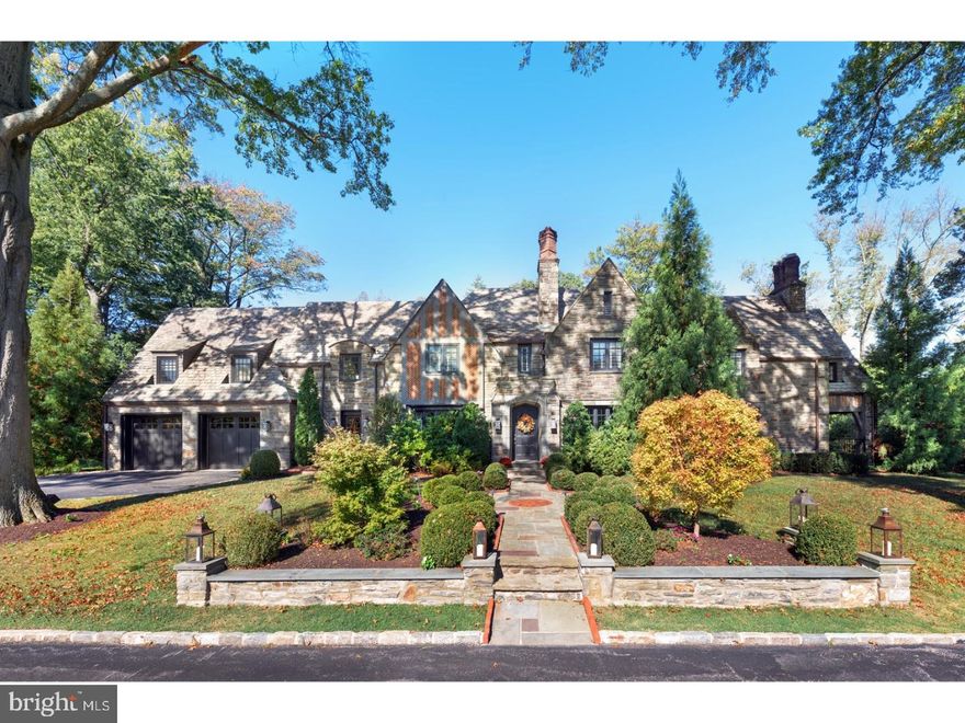 Impressive, sophisticated and entirely renovated,expanded and restyled. A magnificent 1937 stone and brick manor home located steps away from famed Merion Golf course on a well planned,1.34 acres with arrival court, flat play yard, pool and infinity edged hot tub,offers superior luxury on three exquisitely finished levels. Enter to a basket weave marble foyer. Beyond, wide planked floors and sweeping wrought iron main stair offers glimpses of the sun-lit formal dining room, step down living room with fireplace and handsome high lacquered study also with wood burning fireplace. Using the original pattern all windows were replaced during renovation thereby offering functionally updated elements while maintaining the original features of the home. A wine room, Butlers pantry, and cleverly appointed formal powder room that doubles as a full pool bath with a touch panel opening to a concealed shower are also found on the main level. Dynamic kitchen with volume ceiling with focus on an oversized seated stone island is brightened by both eastern and western exposures and through French doors has access to the terraces, covered patio and pool.  A two sided fireplace joins the kitchen to the family room. A vaulted ceiling with turnbuckle trusses adds an industrial element to this gathering space while floor to ceiling windows surround the breakfast table, inviting in views of flat yard and gardens. At the top of the front stair enter to a large master suite. The pitched ceiling in the master bedroom provides charm and architectural detail while generous his and her walk in outfitted closets exceed the expectation of the modern buyer. A full bath with soaking tub, double vanities and seated shower complete the master suite. Two cheerful family or guest rooms share a white tiled jack and jill bath, while across the hall is an en suite bedroom and bath overlooking the pool. Designed for both family as well as guest retreat, the second level family room, adjacent to the back stair and laundry room, makes for the ideal reading, television or bunk space. A two room suite with full bath and morning kitchen expand the guest experience. Both the main stair as well as a secondary stair lead to the finished lower level. A recreation area with fireplace, gym, large walk in wine cellar with custom storage and temperature control, half bath and primary storage complete this level and provide welcome additional informal space to this truly spectacular residence.