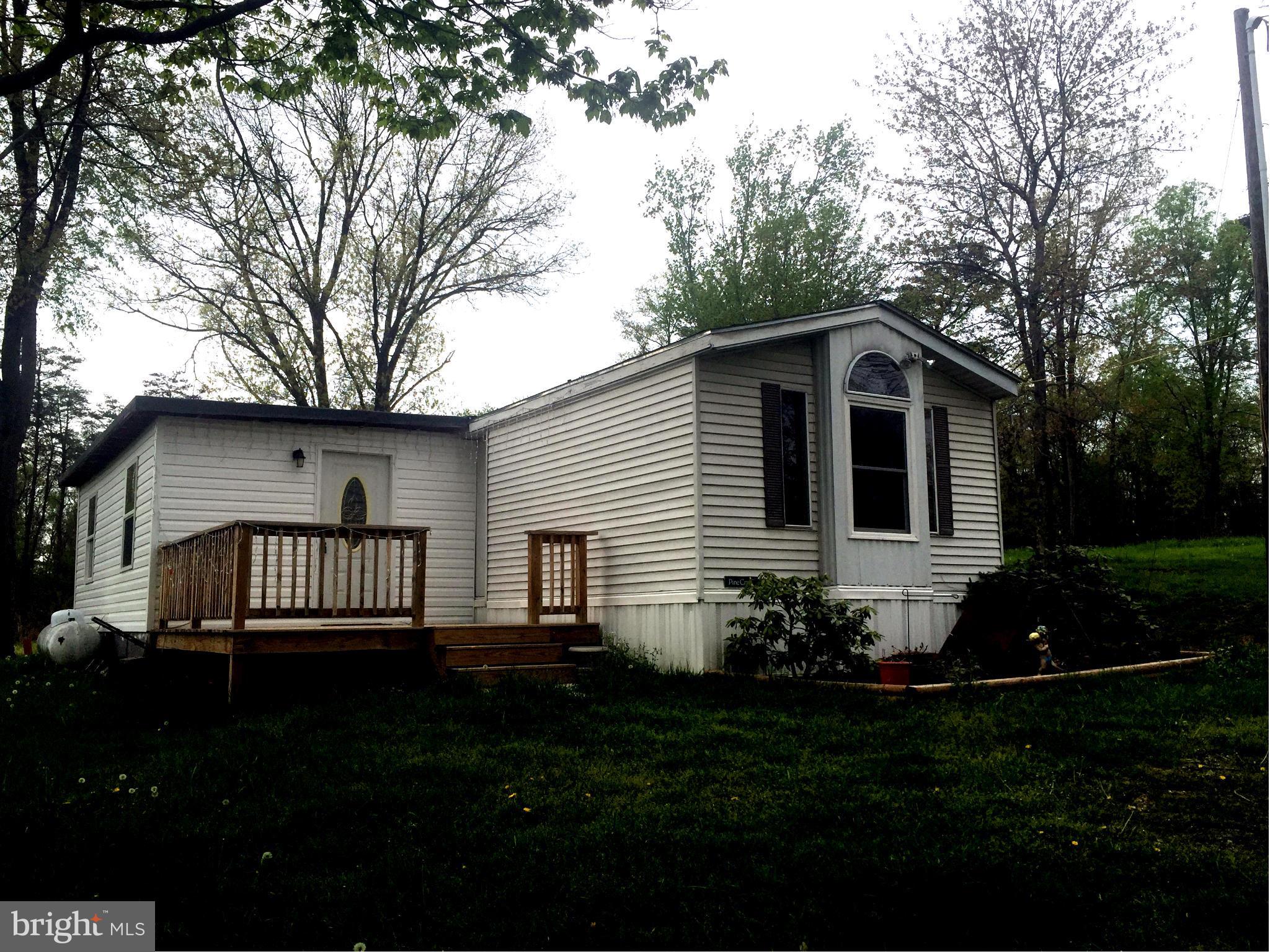 Escape to the hills of WV and bring your horses. 4.205 Ac.24X12 outbuilding used as tack room and work space, with attached run-in stall, and another for hay storage/machinery. 12X12 deck on the front and another off the back laundry room. Property is fenced and ready to give you the Peace and Quiet that only WV and offer. (full or part time living)