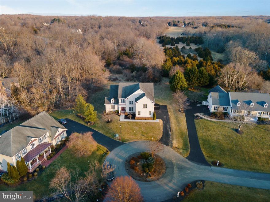 Now priced $50,000.00 below the current appraised value! 
This amazing luxury home is a total of 6,144.85 square feet as confirmed by the recent appraisal! That is 4,023 Sq. Ft above grade finished or 185.93 per Sq. Ft. Plus another 2,122 below grade unfinished, with 9ft ceilings and full bathroom rough-in for future expansion! 
All brick, custom built, one-of-a-kind luxury home is much larger than it appears! The house is positioned on the front of the lot to give this home a large private backyard that backs to wooded area. This luxury home has 5 bedrooms & 4 1/2 bathrooms. Every spacious bedroom has a full bathroom attached! This home features bright foyer with a soaring ceiling, unique chandeliers, hardwood flooring throughout the main level! Formal living room with crown molding and fireplace! Formal dining room with trey ceiling, dramatic underlighting, and beautiful chair molding. Two story family room with walls of windows and glass doors looking out to the back lawn, & the trees beyond. Gourmet kitchen with new stainless-steel appliances, cook top with down draft, granite countertops and tile flooring. The breakfast bar looks out to the family room, breakfast nook and a large walk-in large pantry! There is one primary main level bedroom en-suite with full bathroom, with upgraded cabinetry, granite counter tops, and tub/shower combo. There is also an entry level half bath with sitting area, and a large laundry room with tile flooring. The two car sideload garage with openers has plenty of room for storage. Elegant hardwood stairway takes you to the second-floor overlook area with hardwood flooring! The second level primary bedroom features a trey ceiling, bump-out with large windows and seating area, two walk-in closets, and new carpeting. The primary luxury bathroom has a huge soaking tub with separate walk-in shower with upgraded tile! Two sink areas, both with upgraded cabinetry and granite countertops! Across the hall is yet another large en-suite bedroom with a luxury full bathroom, walk-in shower, upgraded cabinetry with granite countertops. Down the hall are two more bedrooms that share a luxury bathroom, with two sinks, with a tub and shower combination. The full unfinished basement with windows, small side stairs to walk up to the side yard, features a full bath rough-in plumbing for future expansion. The price per above grade Sq ft of 62 Reachcliff Circle is 185.93 per Sq. Ft. which is much lower compared to active and sold homes in the Cress Creek neighborhoods for the past 6 months. Come and see what an opportunity this home Is NOW, as well as an opportunity for future growth by adding an individualized touch via the landscaping, adding a deck and/ or patio and/or finishing off the huge basement with high ceiling.  So many possibilities!