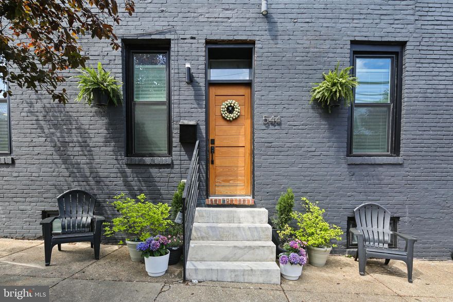 A rare opportunity to own one of the largest and most thoughtfully renovated homes in the heart of Federal Hill. This expansive, end-of-group residence spans four beautifully finished levels, offering a level of space, function, and style that is almost never found in the neighborhood. Step inside to an open and airy main level flooded with natural light. You'll find a spacious living room with a gas fireplace, a separate dining area perfect for entertaining, and a showstopping kitchen featuring a custom-built island, abundant cabinet and counter space, and handcrafted details throughout. A stylish powder room and smart flow between spaces make this level as functional as it is beautiful. The second floor features three generously sized bedrooms—each with great closet space—a full bathroom, and a dedicated laundry room. Upstairs, the entire third floor is a private primary retreat, complete with a spacious en-suite bathroom and direct hallway access to a rooftop deck with panoramic views of the city skyline. The finished lower level adds even more versatility, with a large playroom or flex space, a fifth bedroom, a full bathroom, and plenty of storage. Custom-built cabinets and shelving, excellent storage throughout, one-car parking, and an ideal location just steps from the waterfront, Riverside Park, and everything Federal Hill has to offer—this home is truly one-of-a-kind. If you're looking for space to spread out, high-end finishes, and a layout that lives like a single-family home, this is the one you’ve been waiting for.
