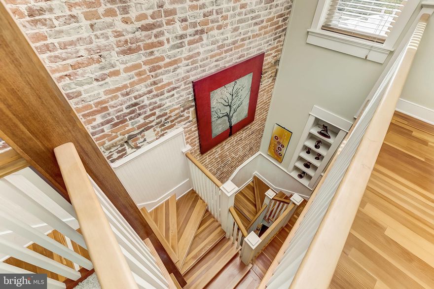 This one-of-a-kind treasure was designed by two architects as their personal residence and must be seen in person to be fully appreciated.  Located on a gorgeous tree-line block, this home was remodeled with the utmost attention to detail and high level craftsmanship including; beautiful Douglas fir hardwoods, 3 levels of radiant/heated floors, a light-filled custom staircase flooded in light by a large skylight, complementary wainscot and brick walls and thoughtful architectural details throughout. The home offers an airy, open concept and is versatile in its design as the second level family room is be easily converted into a third bedroom and several versatile areas in the home which could be utilized as office spaces.  The living room is graced by a beautiful wood-burning fireplace with gorgeous mantel and connects seamlessly to the dining room and kitchen. The light-filled kitchen has granite countertops, stainless steel appliances, beautiful custom cabinetry flows to a half bath and then into the mudroom which provides a great transitional area, provides for additional storage and could be easily used as a home office. The second level has a bedroom, full bath with shower, family room/bedroom and laundry. The bright third level master suite is awash in light from the large skylight and has a bedroom, soaking tub and water closet.  You'll love the private deck surrounded by beautiful mature trees  providing a sanctuary like setting. Additional highlights include:  a new high velocity A/C system, new tankless hot water heater,  new washer and dryer, replacement windows, 2 skylights, a central vacuum and convenient parking pad.  Location is the name of the game, and this home is in a terrific location within the community!  Super close to Riverside Park, Fort McHenry and all the amenities offered throughout Federal Hill, Locust Point and the Inner Harbor.  Just minutes from I-95 and offering ease in commuting both north and south.  1406 Battery Avenue exudes warm and character and is a house you will be proud to call home.