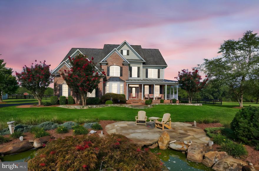 Welcome to this exquisite, impeccably maintained 6-bedroom, 5.5-bathroom estate in the heart of Purcellville, set on nearly 14 acres of tranquil countryside. Upon meandering up the tree lined paved driveway, the home is set back to enjoy the views. This distinguished residence is bathed in natural light and features gleaming hardwood floors throughout. The gourmet kitchen is open to the family room and  complete with top-tier appliances and panoramic views of the expansive, flat yard and outdoor entertaining areas. The family room, with its dramatic two-story ceilings and inviting fireplace, is the perfect space for both grand entertaining and intimate gatherings. The main level also features a full bath and separate bedroom/office space. 
The lavish primary suite is a private retreat, featuring plush carpeting, a BRAND NEW spa-like en-suite bathroom with designer lighting, an expansive dual vanity, a luxurious stall shower with seating, and a soaking tub for ultimate relaxation. Each additional bedroom is generously sized and thoughtfully designed, offering comfort and elegance. The finished lower level provides a large recreation room with stylish tile flooring, a second cozy fireplace, and flexible space for a home theater or gym.
Step outside into your private oasis, where stunning mountain views of Hillsboro Gap and Short Mountain provide the perfect backdrop for outdoor living. The meticulously maintained grounds with mature landscaping and featuring a Koi pond, a large deck, a built-in hot tub, and ample seating areas for alfresco dining or relaxation. 
The property also features a separate three-car garage with high ceilings, ideal for car enthusiasts or those seeking additional living space. The upper level of the garage is a floored and framed making for a versatile area that can be transformed into a private apartment or home office. With 200 AMP wiring for welders and the convenience of propane, sewer, and water lines already run to the building, the potential is limitless. **PARKING FOR ALL your cars, guests and bring your CAMPER**This extraordinary estate offers the perfect combination of luxury, privacy, and breathtaking views, creating a truly unparalleled living experience. NO HOA