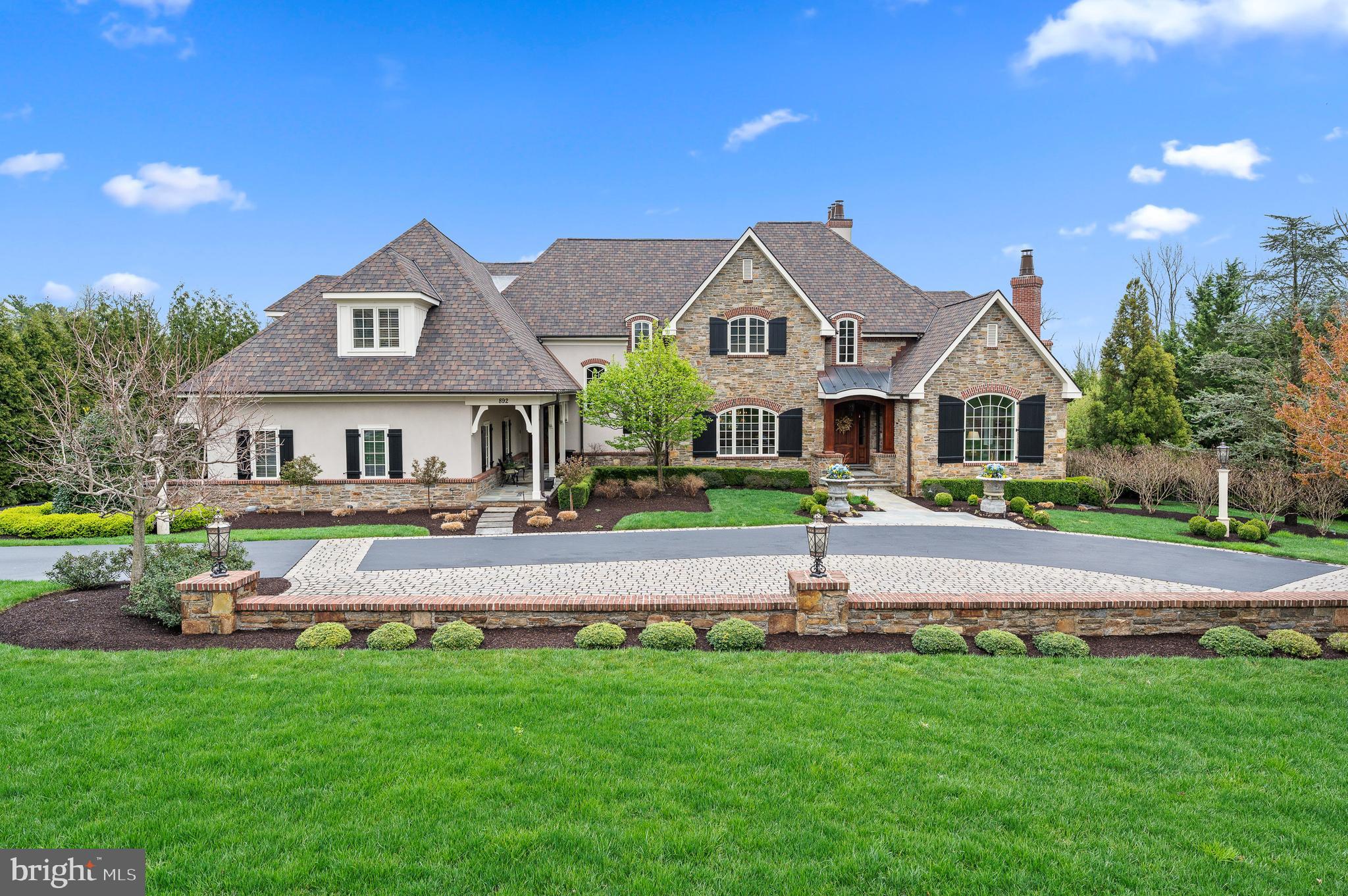 Located in prestigious Gwynedd Valley, is this incredible custom built, & exceptional home designed by renowned architect Rene Hoffman. 12 years young, this custom home is set on a quiet street surrounded by & backing up to a walking trail & 7 acres of open space. Amenities & details to truly appreciate, plus only minutes from the Gwynedd Valley train station. Simply stunning exterior is complete w a Wissahickon Schist cut stone facade & mahogany door. Every room inside has been thoughtfully designed, carefully decorated & impeccably maintained. Offering 9,716 sq ft of living space on 3 levels, class, warmth, & elegance surround you. Quarter sawn oak hardwood floors, arched doorways, custom millwork & attention to detail surpass expectations. Perfectly appointed sitting room w a gas fireplace featuring a stone surround, formal dining room w a tray ceiling, wainscoting & pocket door opening to a custom butler's pantry w dual dishwashers. The gourmet kitchen is loaded w amenities any discerning buyer would expect in a luxury home such as custom cabinetry, high-end appliances, rounded & spacious breakfast room plus views of the flagstone terrace & pool area below. Spacious & stunning family room has a cherry wood coffered ceiling, stone hearth fireplace, complete w 2 sets of French doors to the terrace & wet bar w fridge & ice maker allowing you to entertain w ease. Main level master bedroom suite is simply spectacular featuring a gas fireplace, stained pine tray ceiling, room darkening powered shades, outside access to the flagstone terrace & views of the very private rear grounds. Enjoy the his & her master bathrooms which are complete w radiant heat, water closets, & custom walk-in closets. Finishing off the main level is a home office w custom built-ins, 1st floor laundry room & 2 powder rooms. The 2nd level provides space and comfort for your loved ones featuring custom millwork, 4 en-suite bedrooms offer walk-in custom closet systems & absolutely tasteful finishes. An additional den area w a wet bar adjacent to the 4th en suite bedroom serves as a separate space guests and family can use to relax without being in the main family room or could easily be converted into an In-Law/Au Pair Suite. This wonderful bedroom configuration ensures privacy for family & guests. The amazing finished lower level offers 9.5' ceilings & everything else you need in your special custom home such as a full bar, a climate-controlled wine cellar, another beautiful gas fireplace, a media/recreation room, a home gym, a gorgeous full bathroom, & an abundance of natural light from 3 sets of french doors (and several full size windows) that lead out to flagstone terrace, pool and hot tub. You will be able to truly vacation at home w this backyard oasis that includes a gorgeous in-ground pool & hot tub, lower & upper flagstone terraces & outdoor fireplace for relaxed evenings w loved ones and guests. Professional hardscaping & landscaping w irrigation & professional outdoor lighting system. Quality of this magnitude is not easy to find. Additional features include: 5 fireplaces all gas (Outdoor fp & front room fp can be converted back to wood burning), solid interior doors, custom millwork, security system w zoned cameras, sprinkler system w well, central vac, 6 Zone HVAC w humidifiers, reverse osmosis water system including water softeners, 600 AMP electrical & generator plus heated garage floors w a gladiator garage system to keep all your things organized . Located in top ranked & award winning Wissahickon School District & also close proximity to several prestigious private schools. Please request your own private tour of this special home to see the property in person & allow us to showcase your new lifestyle!