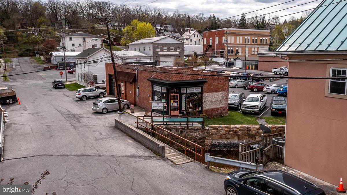 EXCELLENT LOCATION! Located in the heart of downtown Berkeley Springs. This historic building was totally remodeled in 2017 with no expense spared. 1800 square feet of finished space for your business or even your home if you would like. This building features: 2 - 200 amp service panels, new wiring and plumbing, red oak hardwood floors, mini splits for heat and AC, full bath, partial kitchen, room with garage door, laundry tub, all new fixtures. (Room partitions can be removed easily!) PLUS 36 solar panels = $15 per month electric bill plus you will earn credits. Public water & sewer. Walk to all the downtown shops, restaurants, spas, brewery, Ice House for events and the Berkeley Springs State Park.