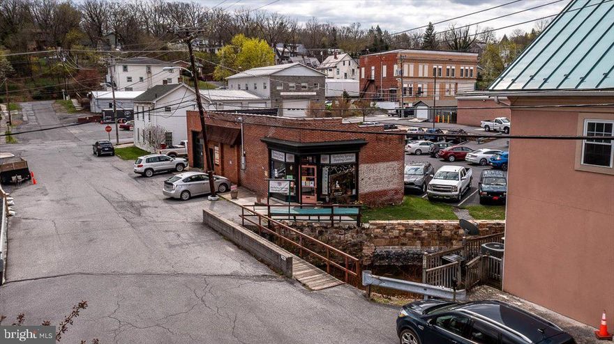 EXCELLENT  LOCATION!   Located in the heart of downtown Berkeley Springs.   This historic building was totally remodeled in 2017 with no expense spared.   1800 square feet of finished space for your business or even your home if you would like.   This building features:  2 - 200 amp service panels,  new wiring and plumbing, red oak hardwood floors,  mini splits for heat and AC,  full bath, partial kitchen,  room with garage door, laundry tub, all new fixtures.   (Room partitions can be removed easily!) PLUS 36 solar panels = $15 per month electric bill plus you will earn credits.    Public water & sewer.   Walk to all the downtown shops, restaurants,  spas, brewery, Ice House for events and the  Berkeley Springs State Park.