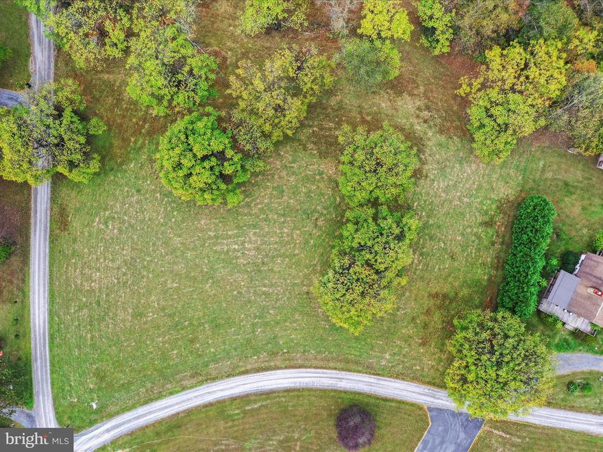 Bring Your Builder! Escape the noise and enjoy the serenity of this mainly cleared lot! This vacant lot offers a quiet country setting surrounded by open space and natural beauty—perfect for building your dream home or weekend retreat. Experience peaceful living while remaining just a short drive to downtown Berkeley Springs or Hedgesville! Sleepy Creek Wildlife Management Area, Potomac River, Cacapon State Park and Whitetail Ski Resort are just some of the areas outdoor attractions! Neighboring home located at 55 Peach Orchard Lane also for sale.
