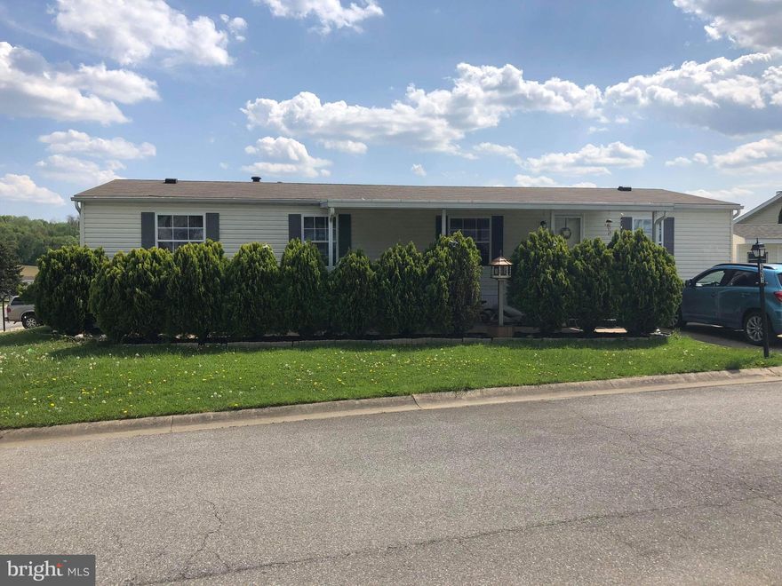 Updated Fleetwood Broadmore on corner lot with covered front porch & patio area. Enjoy entertaining in the spacious open concept kitchen, dining & living area. Bonus room perfect for office or playroom. New washer.  $430/month lot rent includes trash, basic cable & use of community pool. Buyer to make application with the park upon offer acceptance. Selling "As Is".