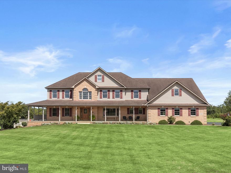 Set on 12 breathtaking acres of pristine landscaping and pasture, this exceptional estate blends refined living with equestrian amenities. The property features a three-car garage, a two-stall barn with automatic waterers installed and space for several more stalls easily, a lofted shed, and two pastures, one that can be divided into three separate paddocks. Three run-ins in the front pasture and two in the back provide ideal shelter for horses, goats, cows, or pigs, making this a true retreat for equestrians or homesteaders alike.  A sweeping front porch welcomes you into the main level, where gorgeous hardwood floors and a dramatic two-story foyer with a Palladian window and intricate glass accents bathe the home in natural light. The formal dining room exudes sophistication with a bay window, chair railing, and crown molding, while a private office with plush carpet offers the perfect work-from-home sanctuary. The spacious living room impresses with a gas fireplace, recessed lighting, and custom built-ins, and opens through French doors to a wraparound porch with serene views of rolling hills, perfect for seamless indoor-to-outdoor entertaining.  The gourmet kitchen is a chef’s delight, boasting Corian counters, dual islands including one with a breakfast bar, 42” cabinetry with display features, sleek appliances, and double ovens. A sun-filled breakfast area overlooks the grounds and provides access to the rear lanai, heated in-ground pool, and lounge area, creating the ultimate space for relaxation and entertaining.  The luxurious primary suite is a true retreat with a spacious bedroom, two walk-in closets with custom organizers (one connecting to a private bonus room), and a spa-like en-suite bath featuring dual vanities, a jetted soaking tub, a walk-in shower, and a walk-in linen closet. Four additional bedrooms, some with built-in bookcases, and a dual-entry hall bath complete the upper level.  The fully finished lower level expands the living space with luxury vinyl flooring, a game and exercise area, a bar with Corian counters, a wet bar with ice maker, a wine rack, and a gas stove.  The basement could also function as an in-law suite with a few modifications. With additional access to the pool area, built-ins, a full bath, and generous storage, this level is designed for both convenience and entertainment.  Perfectly situated near MD-140, MD-194, and I-795, this remarkable property offers a rare combination of luxury living, farm amenities, a three-car garage, and scenic tranquility. Shown by private appointment only.