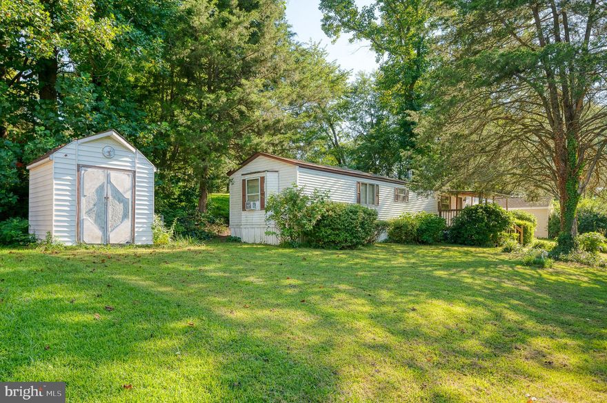 WELCOME HOME TO THIS 2 BEDROOM/2 BATHROOM HOME! FRONT ENCLOSED PORCH. KITCHEN HAS UPGRADE CABINETS, FORMICA COUNTERTOPS. WARM COZY, WOOD FIREPLACE IN LIVING ROOM. PRIMARY BEDROOM HAS LARGE PRIMARY BATHROOM WITH GARDEN TUB. LARGE LOT SPACE. SECLUDED BACKYARD WITH BACK PORCH. NEW WASHER AND DRYER. 2021 NEW HEAT PUMP. 2019 WATER HEATER REPLACED. LOT RENT INCLUDES WATER, SEPTIC AND TRASH. CAN EASILY BE CONVERTED BACK TO A 3 BEDROOM. AS A NICE BONUS THE SHED WITH ADDITIONAL SUPPLIES AND TOOLS ALSO CONVEYS!