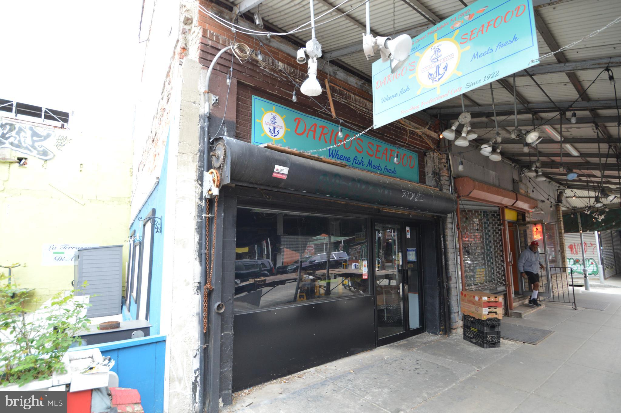 Rare opportunity on iconic 9th Street in Philadelphia’s historic Italian Market. Welcome to 1015 S 9th Street, the former longtime home of Darigo Seafood, now available for the next visionary owner to make their mark in one of Philadelphia’s most storied commercial corridors. Located in the heart of the Italian Market, this three-story CMX-2 zoned mixed-use property offers unmatched visibility, foot traffic, and historic charm.
The first-floor retail space features a traditional glass storefront secured by a roll-down padlocked gate and is in turnkey condition. Formerly used for seafood sales, it includes negotiable equipment such as ice machines, a walk-in refrigerator box, sorting tables, and other business fixtures, making it ideal for a new owner-operator or creative retail concept. The layout is open and flexible, perfect for capturing the energy and pedestrian activity of the market.
Access to the second and third floors is currently through a pull-down aluminum ladder, similar to accessing attic space. These upper levels were once a residential unit for the business owner but are now raw, undeveloped space in need of renovation. The CMX-2 zoning allows for a wide range of uses, including residential, office, or extended commercial space, giving the next owner flexibility and opportunity to reimagine the property.
The Italian Market is not only a Philadelphia institution but a national destination known as the oldest continuously operating outdoor market in the country. This stretch of 9th Street is alive with local vendors, longtime residents, tourists, and film history, famously featured in the Rocky series. The location benefits from constant foot traffic and a deep cultural identity that draws new businesses and customers alike.
Positioned within walking distance to Center City and close to neighborhoods like Bella Vista, Passyunk Square, Queen Village, and Washington Square West, the property is also well-connected by public transportation and major commuter routes. Whether you're an investor or an entrepreneur looking to plant your flag in one of the city’s most vibrant and visible locations, 1015 S 9th Street offers a rare chance to be part of a legacy location with future upside.