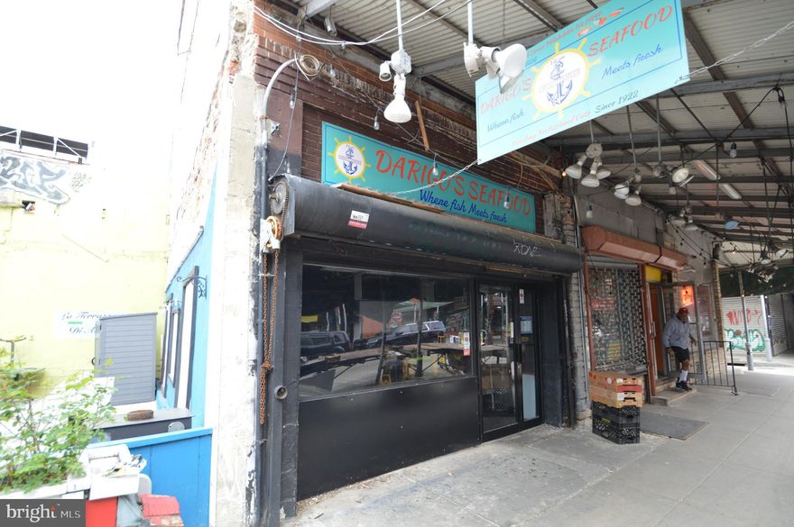 Rare opportunity on iconic 9th Street in Philadelphia’s historic Italian Market. Welcome to 1015 S 9th Street, the former longtime home of Darigo Seafood, now available for the next visionary owner to make their mark in one of Philadelphia’s most storied commercial corridors. Located in the heart of the Italian Market, this three-story CMX-2 zoned mixed-use property offers unmatched visibility, foot traffic, and historic charm.

The first-floor retail space features a traditional glass storefront secured by a roll-down padlocked gate and is in turnkey condition. Formerly used for seafood sales, it includes negotiable equipment such as ice machines, a walk-in refrigerator box, sorting tables, and other business fixtures, making it ideal for a new owner-operator or creative retail concept. The layout is open and flexible, perfect for capturing the energy and pedestrian activity of the market.

Access to the second and third floors is currently through a pull-down aluminum ladder, similar to accessing attic space. These upper levels were once a residential unit for the business owner but are now raw, undeveloped space in need of renovation. The CMX-2 zoning allows for a wide range of uses, including residential, office, or extended commercial space, giving the next owner flexibility and opportunity to reimagine the property.

The Italian Market is not only a Philadelphia institution but a national destination known as the oldest continuously operating outdoor market in the country. This stretch of 9th Street is alive with local vendors, longtime residents, tourists, and film history, famously featured in the Rocky series. The location benefits from constant foot traffic and a deep cultural identity that draws new businesses and customers alike.

Positioned within walking distance to Center City and close to neighborhoods like Bella Vista, Passyunk Square, Queen Village, and Washington Square West, the property is also well-connected by public transportation and major commuter routes. Whether you're an investor or an entrepreneur looking to plant your flag in one of the city’s most vibrant and visible locations, 1015 S 9th Street offers a rare chance to be part of a legacy location with future upside.