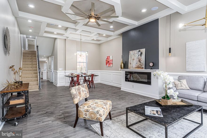 BEYOND SPECTACULAR RENOVATION WITH 4 FINISHED LEVELS AND 2 CAR PARKING! Open floor plan featuring a spacious living room with coffered ceiling, fireplace, and dining area, gourmet island kitchen with Quartz counters, ss appliances, and a walk-in pantry, main level half bath, 2nd level with 3 bedrooms, 1 full bath, and desirable bedroom level laundry, expansive 3rd level Primary suite with vaulted ceiling, walk-in closet and a spa bath with double sinks & a whirlpool tub, a fully finished basement with a family room, 5th bedroom, a 3rd full bath and an abundance of storage space, and 2 car off street parking! Property is eligible for 10k Vacants to Value grant! Conveniently located close to downtown Baltimore, UMMC, stadiums, and major roadways! Same builder has other units available for pre-sale - call Listing Agent for details