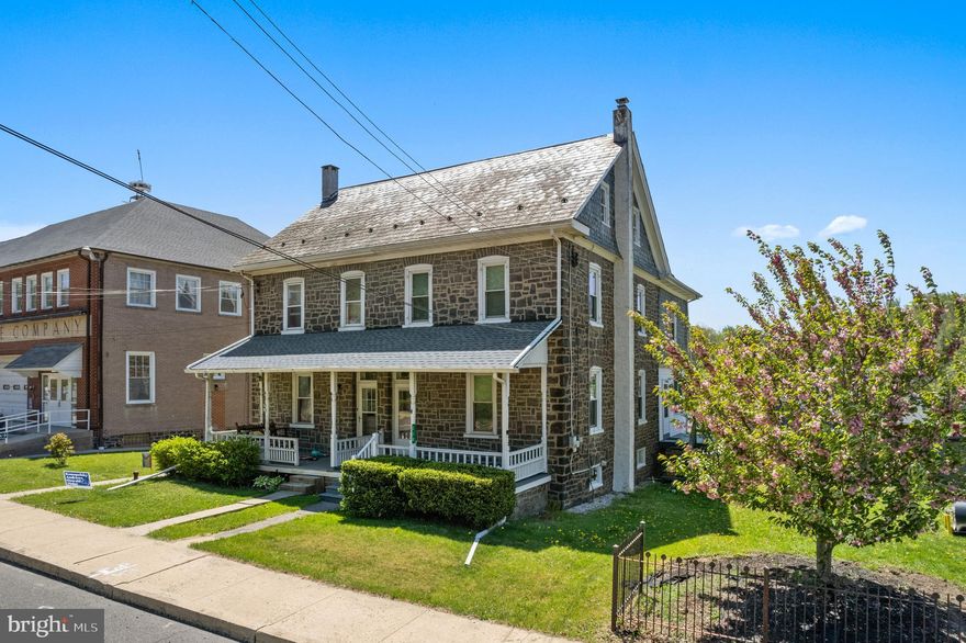 Welcome to 210 Main St., offering a front porch just made for summer evenings and a first floor layout that flows nicely. The living room and dining room are both spacious with pocket doors between them.  The large eat-in kitchen has plenty of updated cabinetry, a large island with more cabinets, a pantry closet and a sunny dining area with a door leading to the side deck. The second floor layout offers three bedrooms. The primary bedroom offers a cedar cabinet with additional storage space above and hardwood flooring and there are two additional bedrooms on this level. A full bathroom with tile shower/tub as well as a small dressing room area outside the bathroom complete this level. The two-room attic has hardwood flooring and while currently unheated, could be easily finished into a fourth bedroom and sitting area with the addition of heating. The basement is a true walk-out to the backyard and the owners are leaving the washer and dryer as well as three workbenches for the convenience of the buyer.  There is also a sink and toilet in the basement. You’ll be charmed by the original stained woodwork and doors throughout the home as well as other features such as the deep windowsills. A detached two car garage is accessible from the rear alley and offers space for two cars to park behind the garage as well. Note, the borough maintains and plows this alley. The oil tank is newer; all windows on the first and second floors are newer; the bathroom was updated in 2018; water heater is newer. There are an abundance of parks in the Upper Perk Valley, both county and municipal. Isaac Smith park is just a two block walk and the Green Lane Park, part of the Montgomery County Park system, is nearby.  Green Lane Park offers 3400 acres of parkland and 20 miles of trails providing a multitude of recreational opportunities including hiking, fishing, boating, horse trails, playgrounds and special events. The home is conveniently located and the PA Turnpike interchange #31 in Towamencin Township is just minutes away.  NOTE:  This home is being sold “as is”, i.e., buyers are welcome to have inspections but should expect no repairs or credits in lieu of repairs as a result of those inspections.