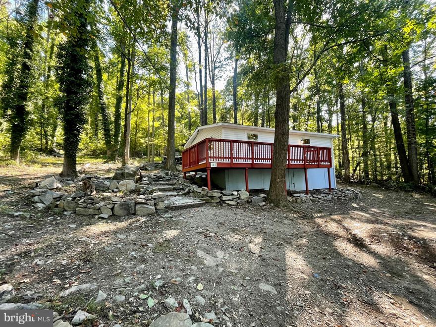 Private, wooded setting surrounding this cute 2 bedroom bungalow on the mountain!  Newly renovated including a new roof, vinyl siding, heat pump, kitchen, bathroom, LVP flooring, and more!  The kitchen offers white cabinets with quartz countertops and brand new stainless steel appliances.  Just sit on the front deck and listen to the birds!  Could make a great AirBnB, VRBO vacation rental or weekend getaway!  This neighborhood backs up to the Appalachian Trail and is minutes from downtown Harpers Ferry and Harpers Ferry Brewing and 340.  Has public water.  It is believed to have high speed internet.  The community has a fishing pond stocked for the community.